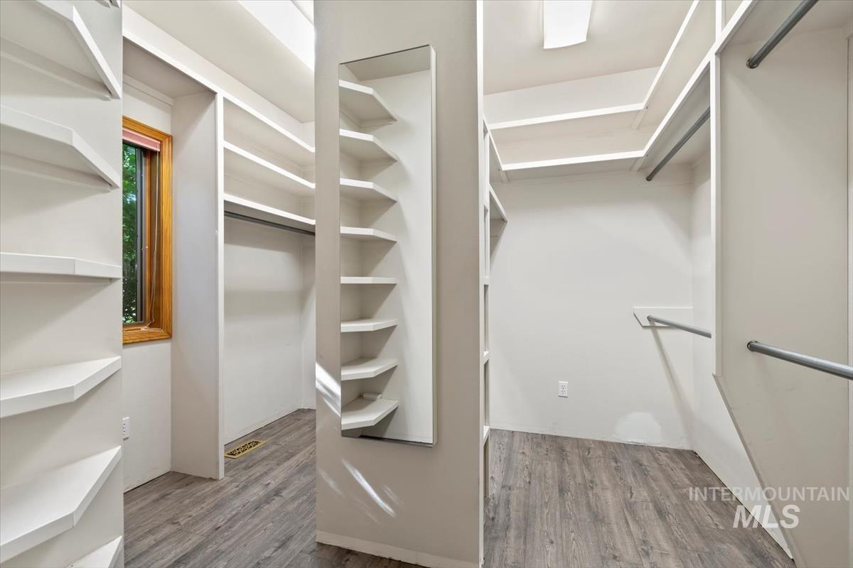 Spacious closet with light wood-type flooring