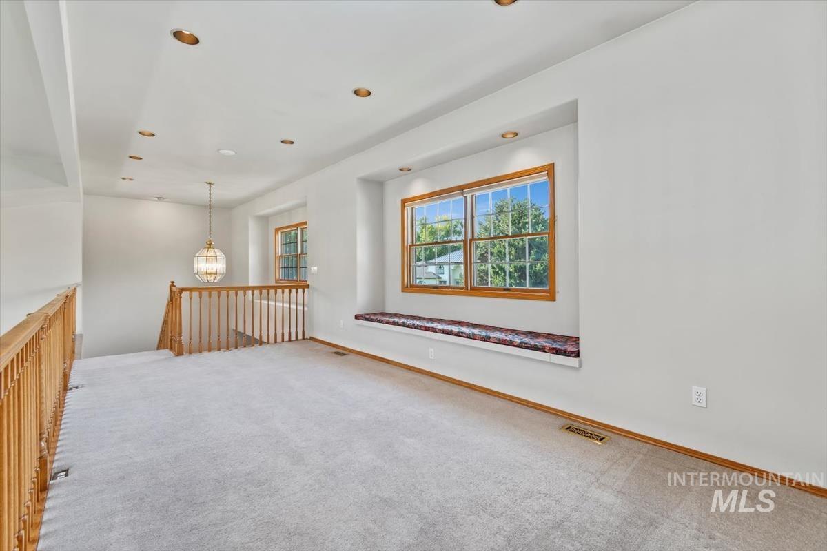 Empty room featuring carpet flooring and recessed lighting
