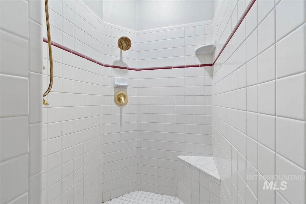 Full bath featuring a tile shower