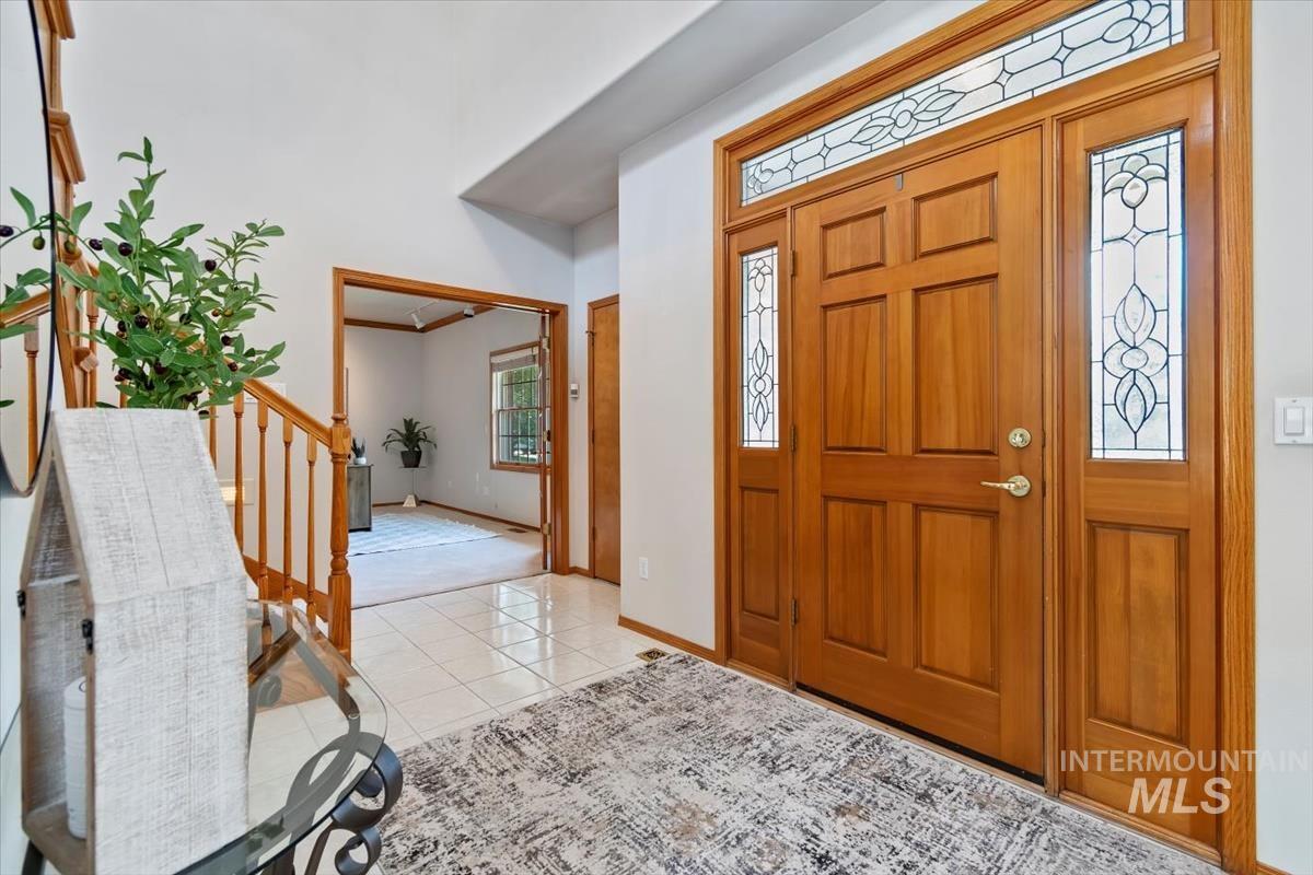 Entryway featuring light tile patterned floors and baseboards