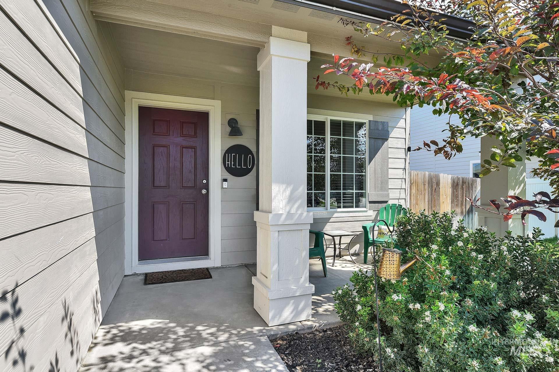 Doorway to property featuring covered porch