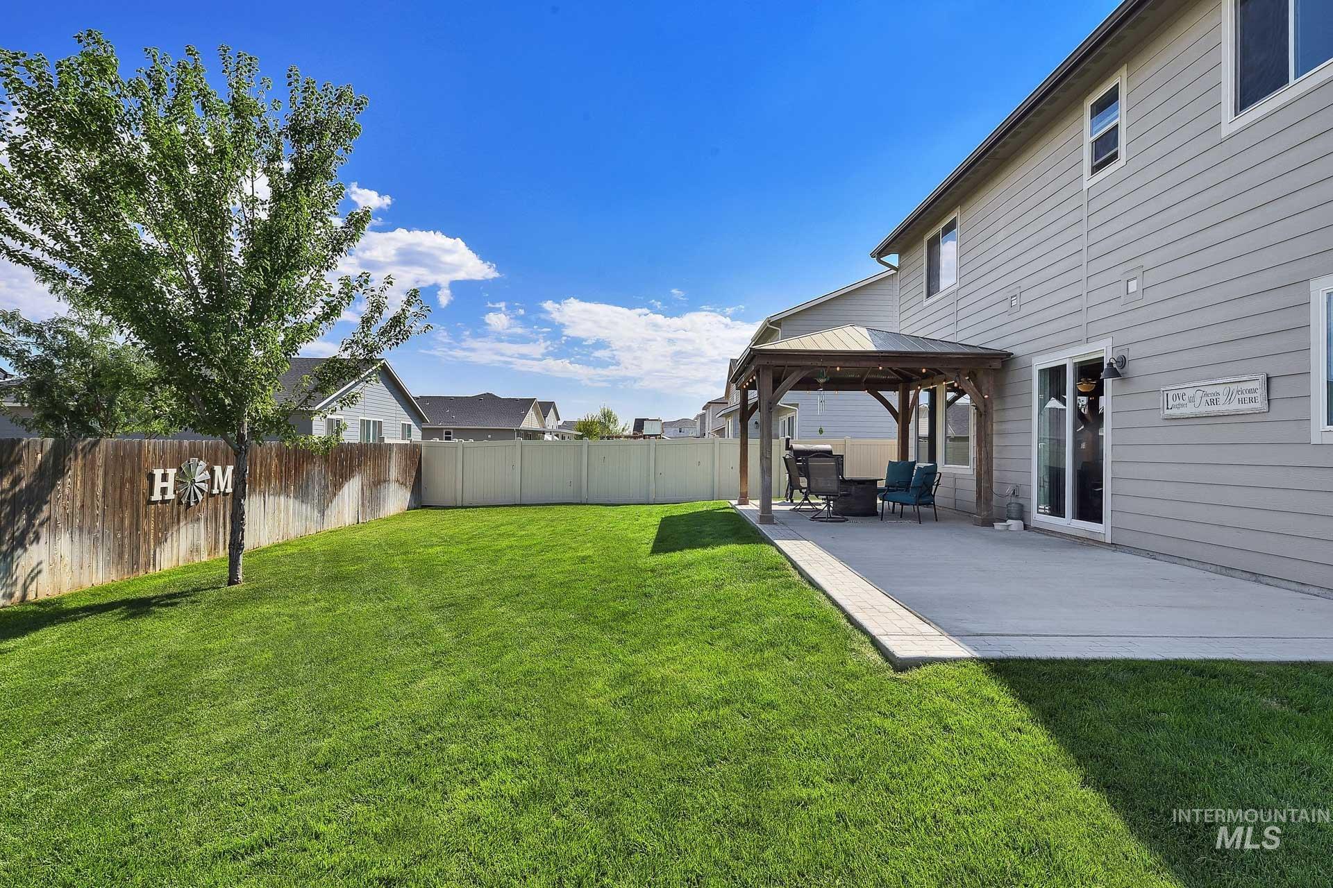 Fenced backyard with a gazebo and a patio