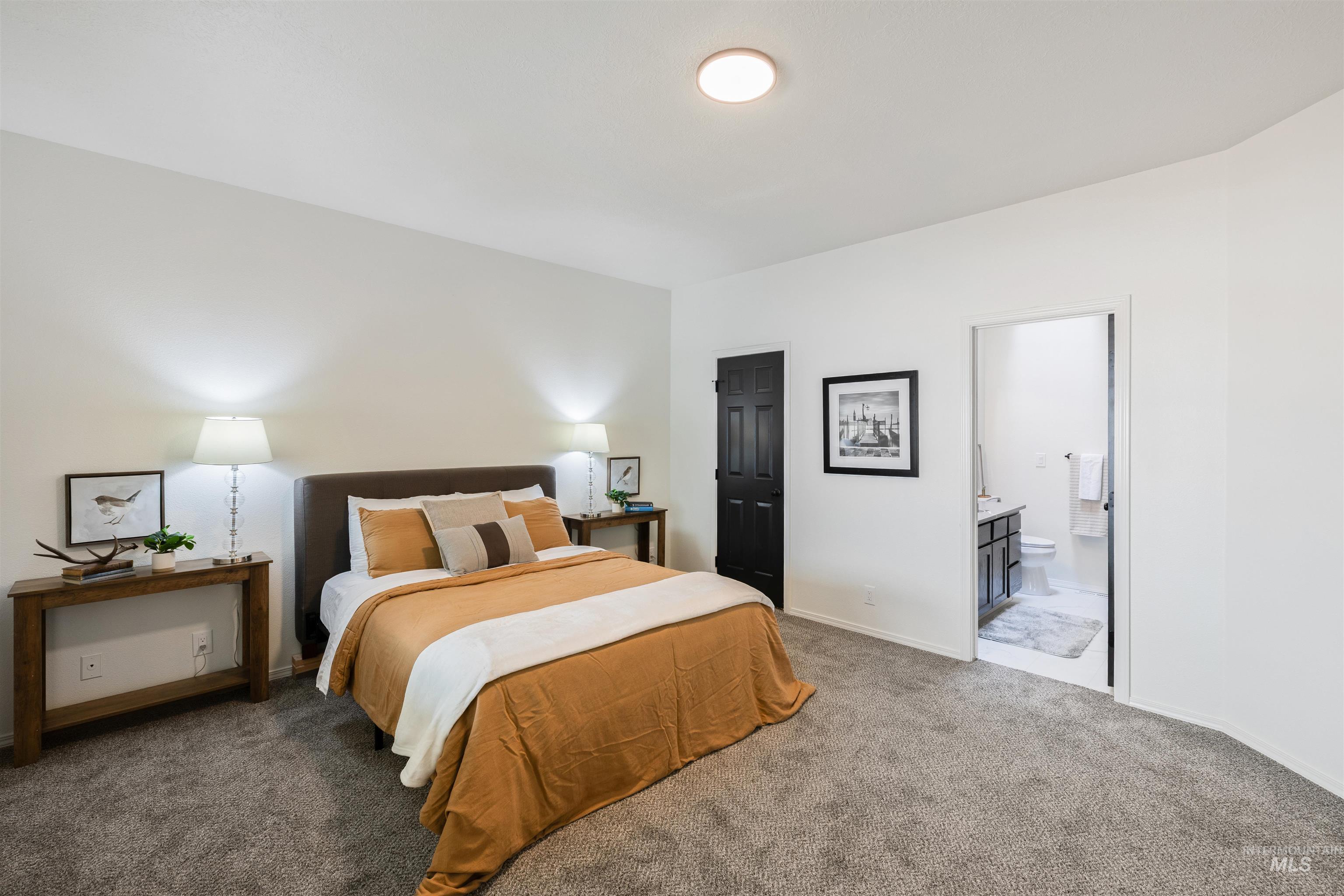Bedroom featuring carpet floors and ensuite bathroom