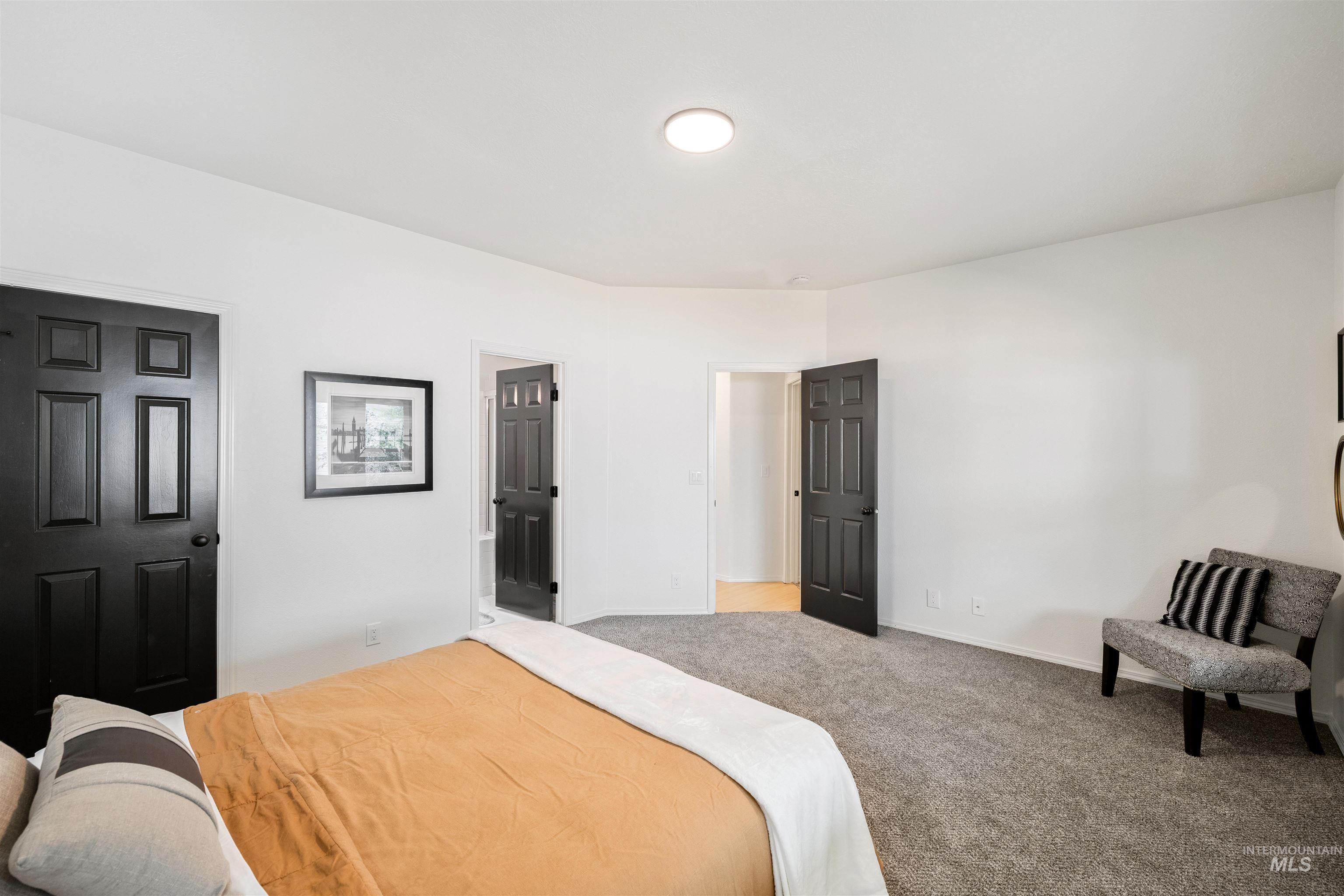 Carpeted bedroom featuring baseboards