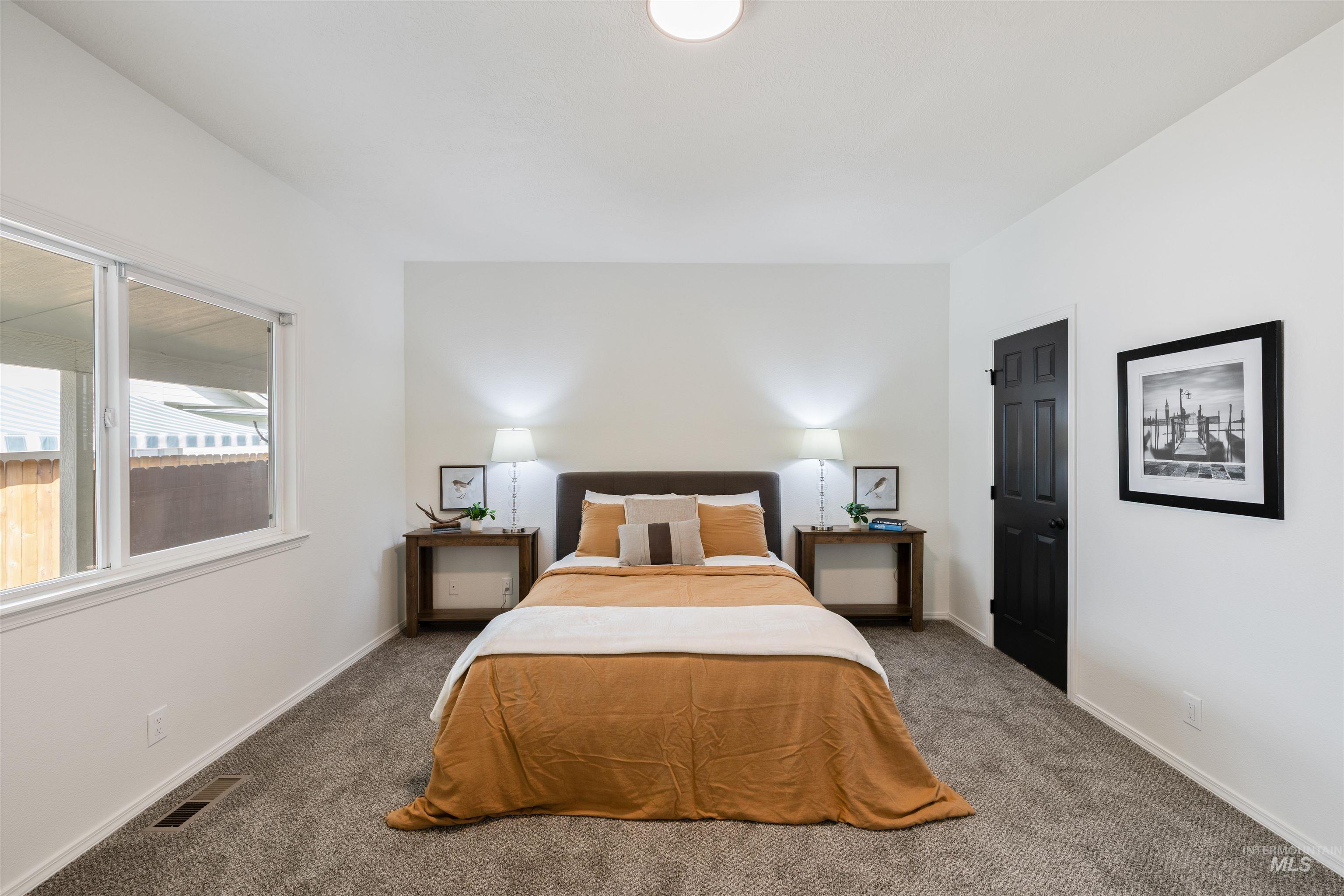 Bedroom featuring carpet floors and baseboards