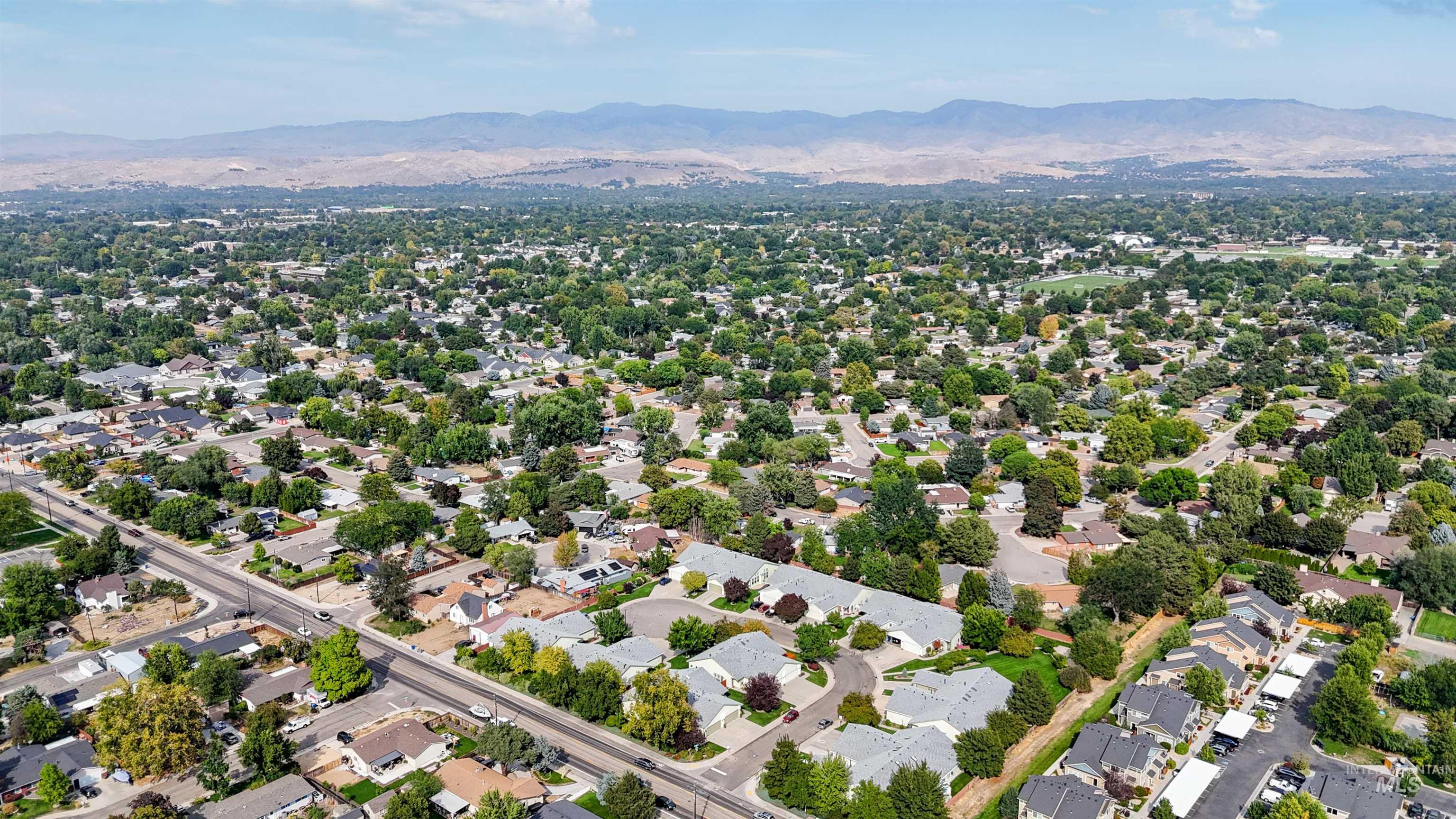 Aerial view of residential area featuring mountains