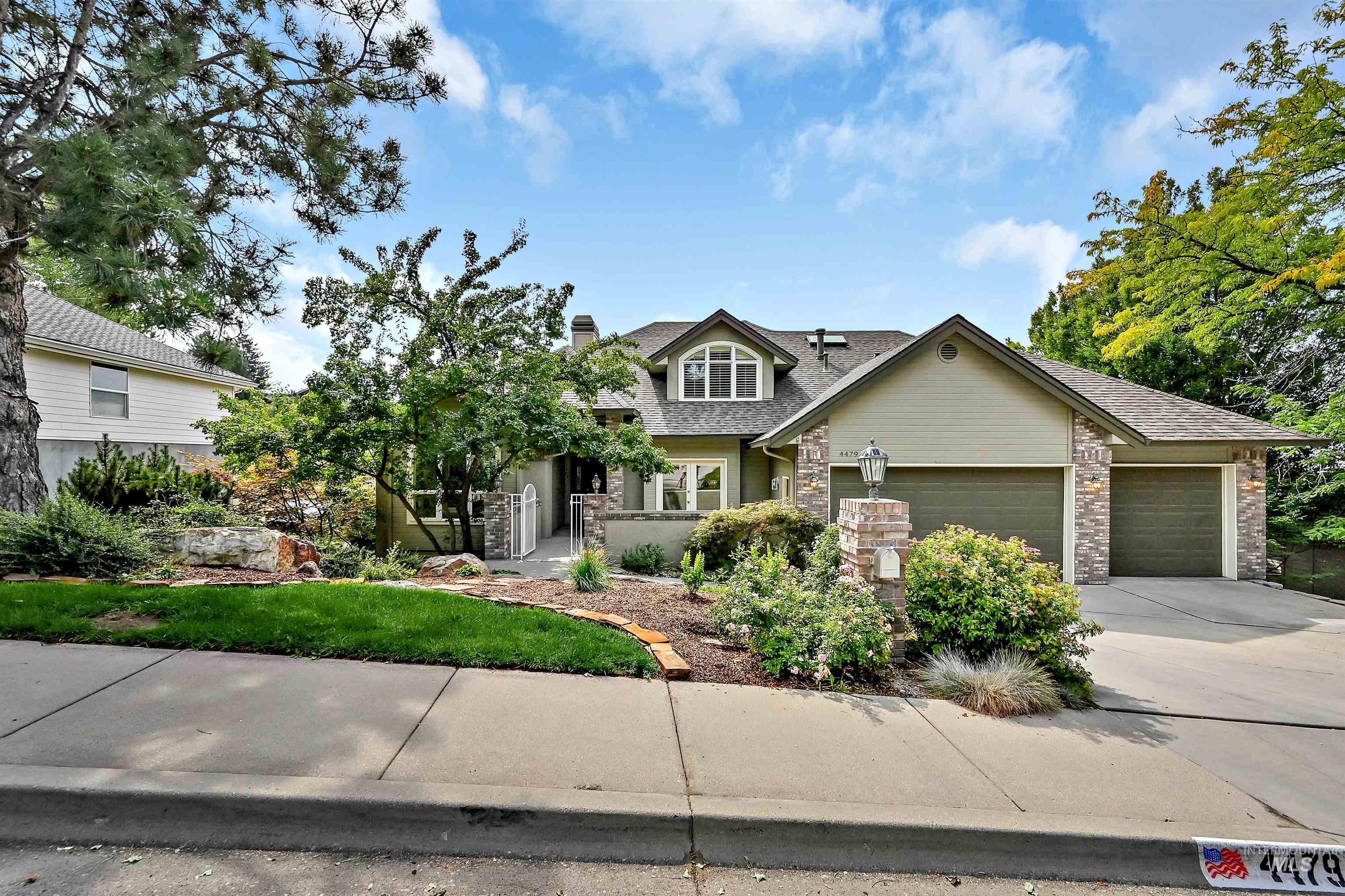 Craftsman-style house with a chimney, driveway, a garage, stone siding, and roof with shingles