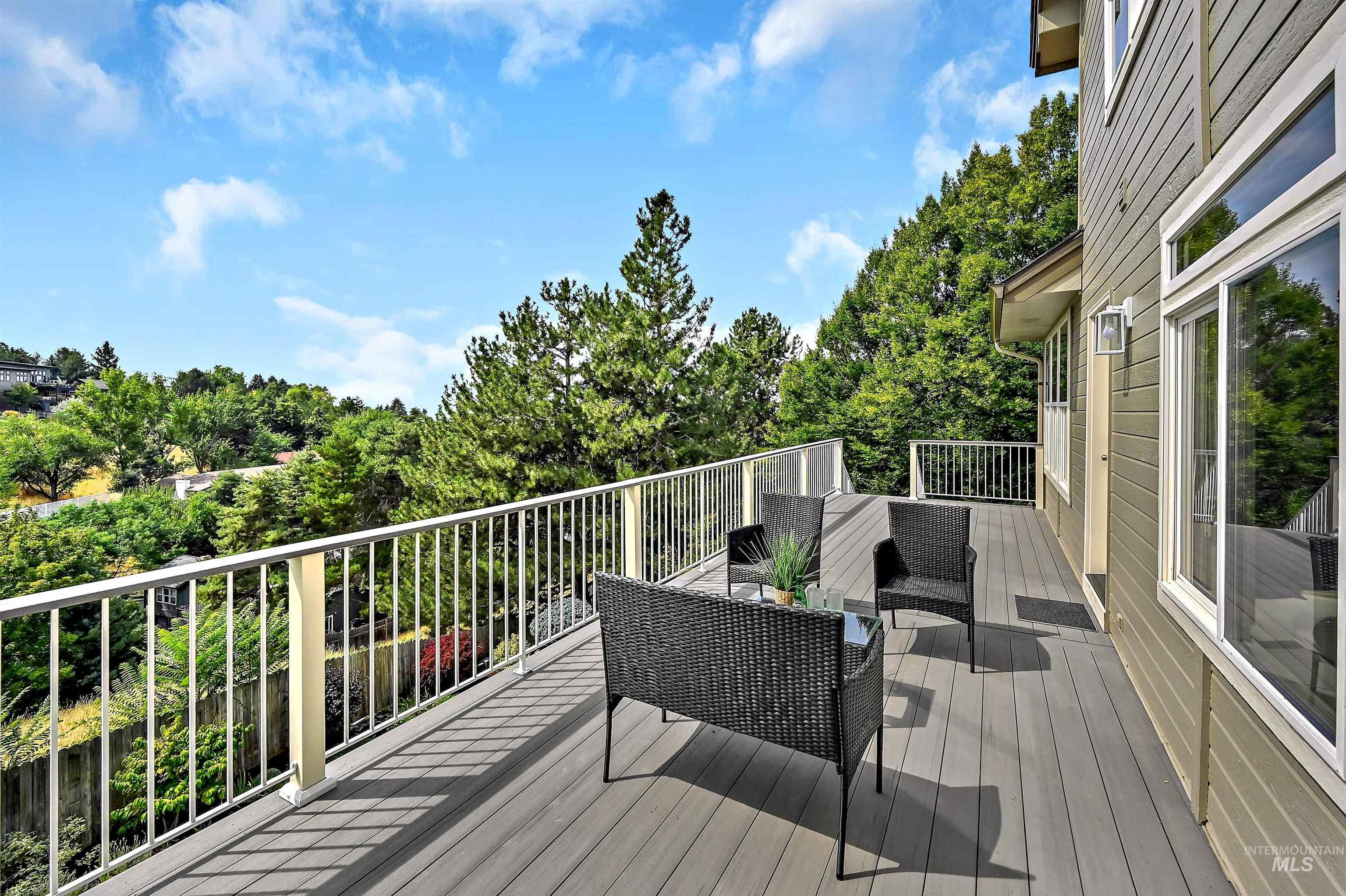 Deck featuring an outdoor living space and view of wooded area