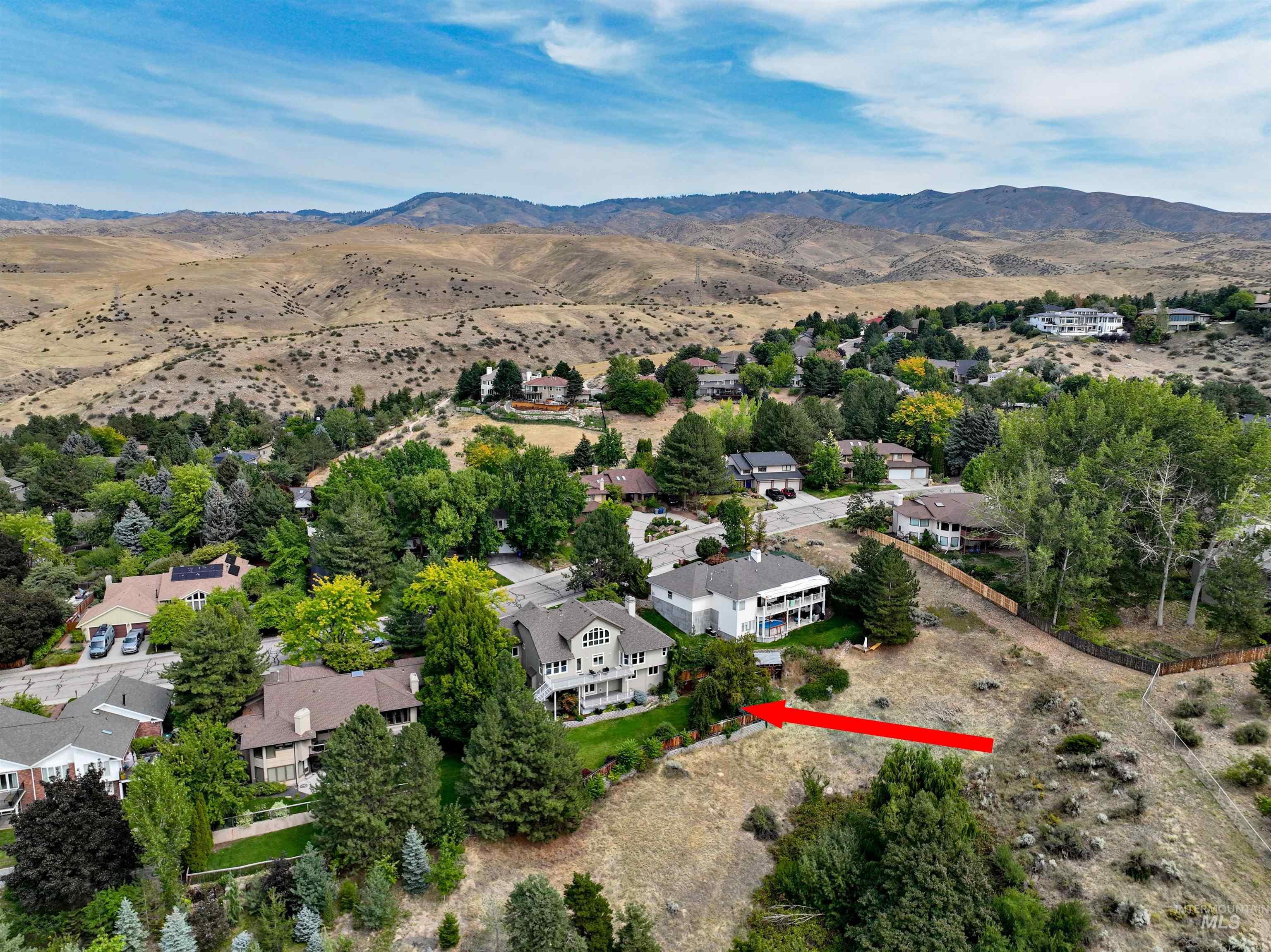 View of property location with a mountainous background and nearby suburban area