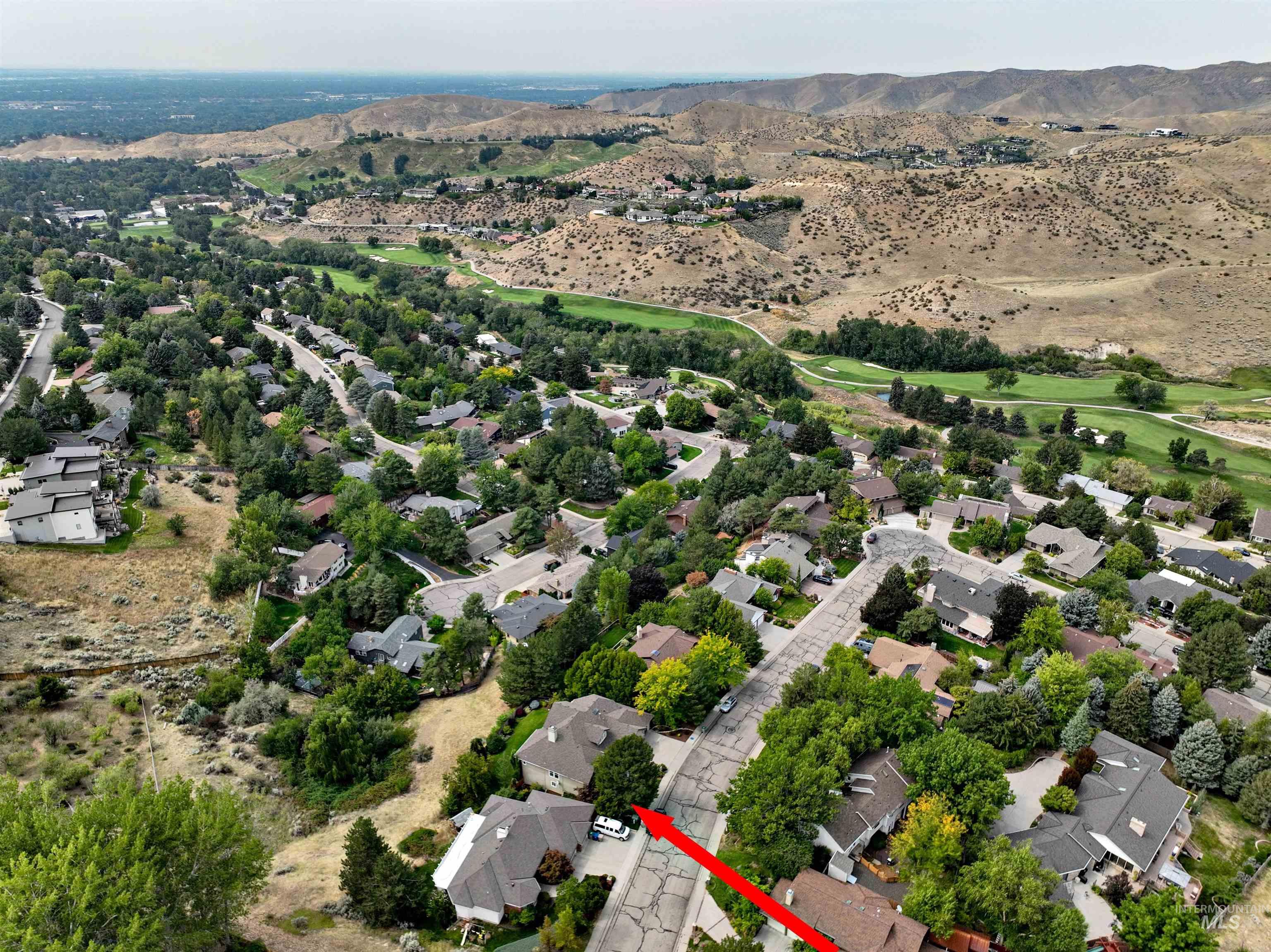 Aerial view of residential area with mountains and a desert landscape