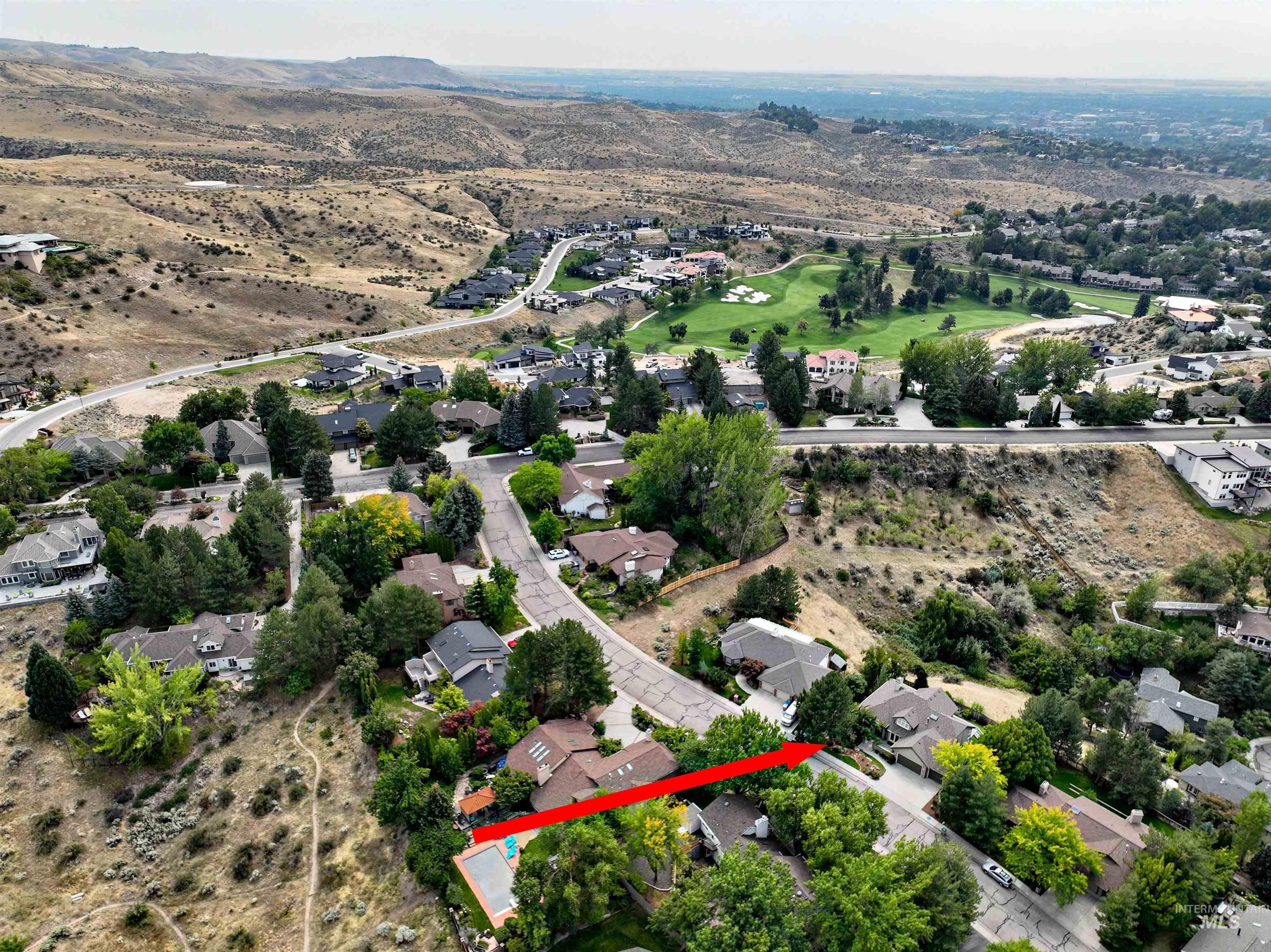 Aerial overview of property's location featuring nearby suburban area and property parcel outlined