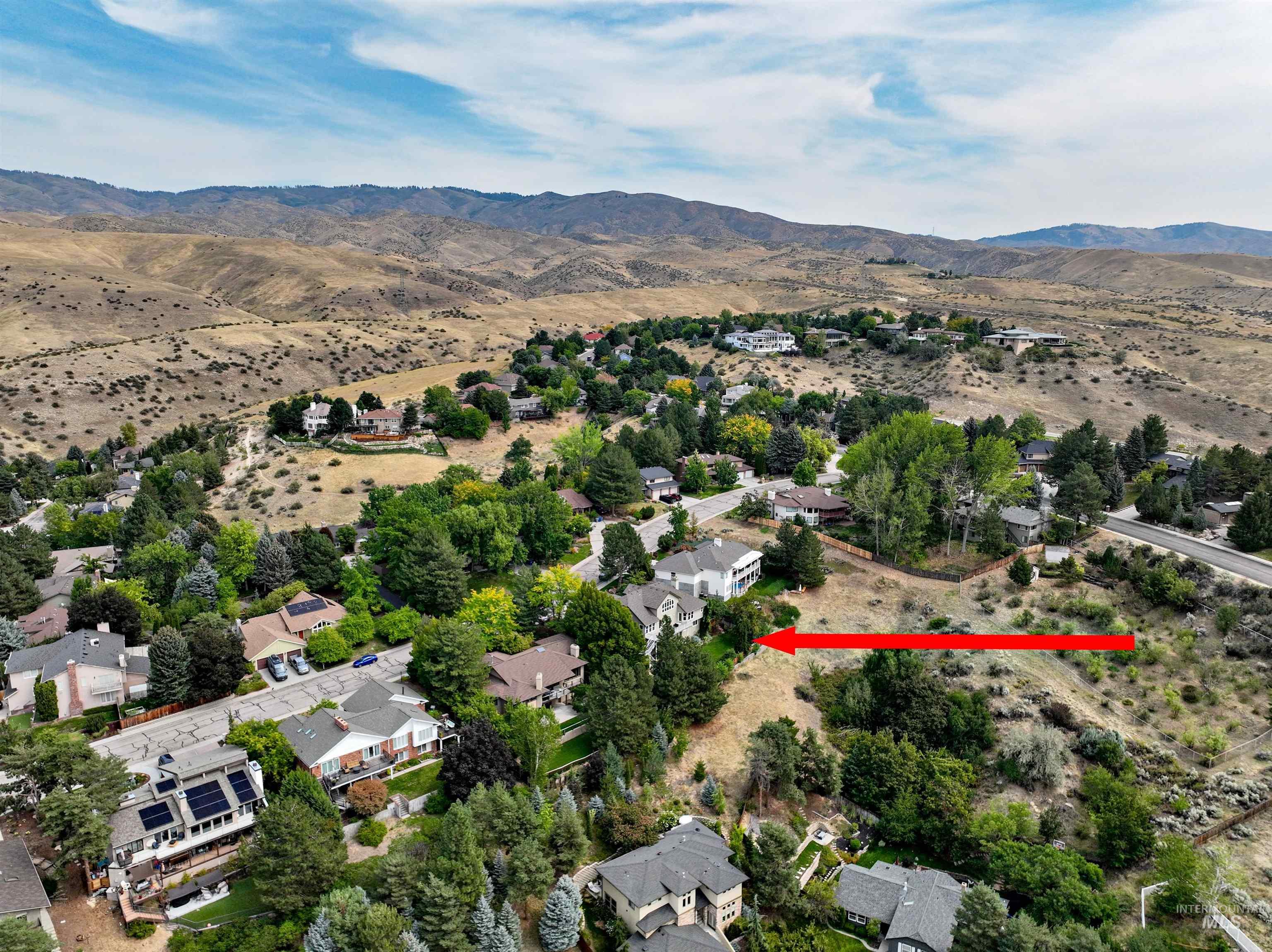 Aerial overview of property's location featuring nearby suburban area and rural landscape