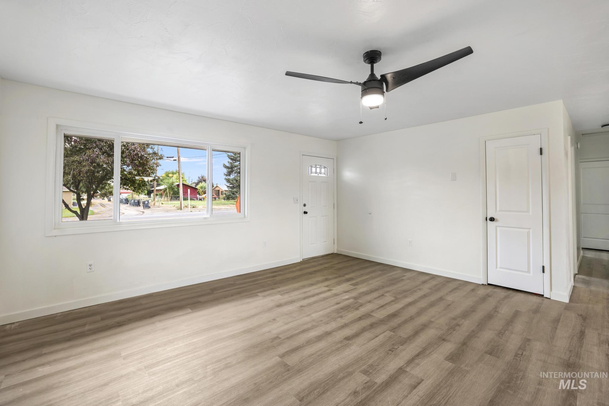 Foyer entrance featuring wood finished floors and ceiling fan