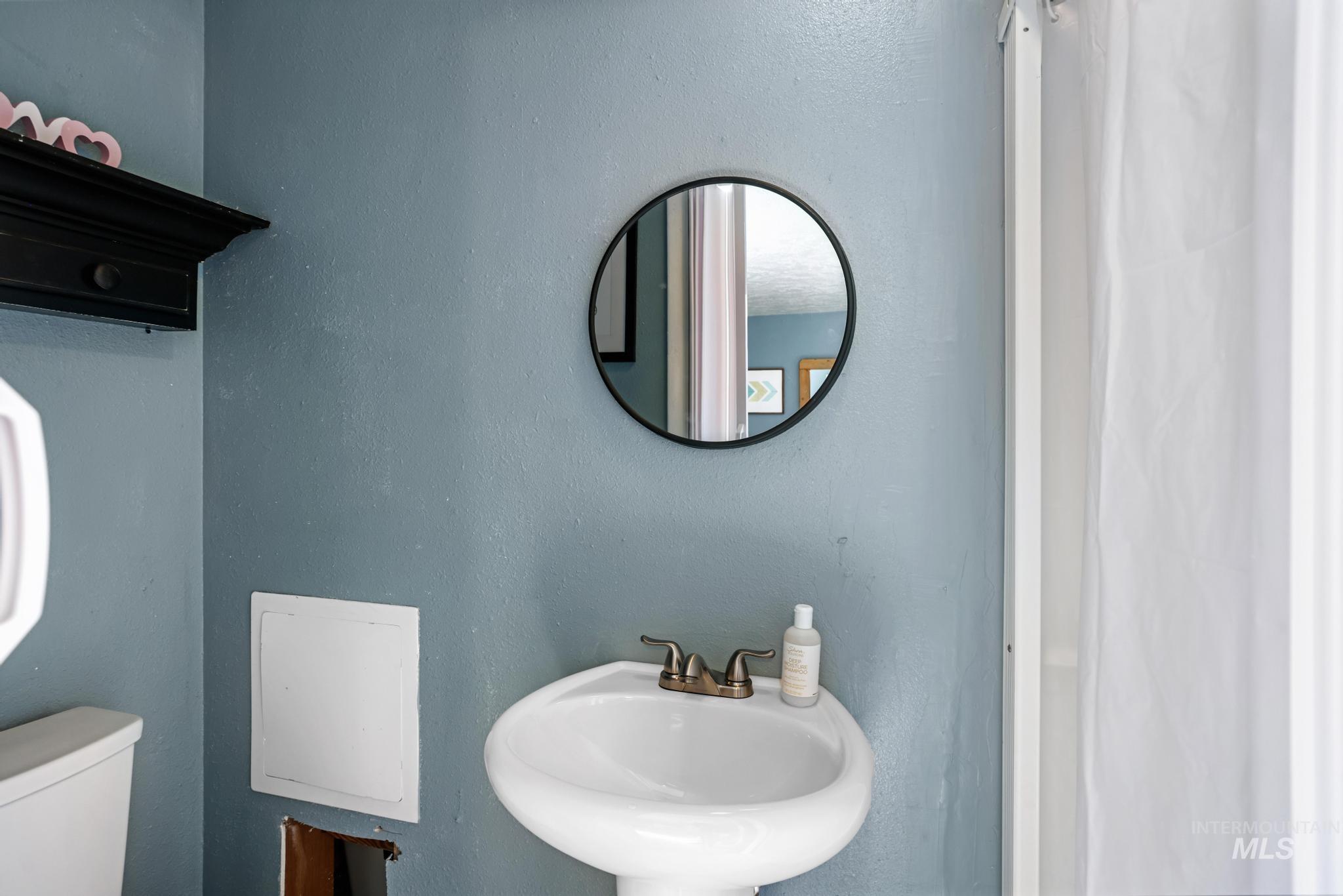 Bathroom with a sink and a textured wall