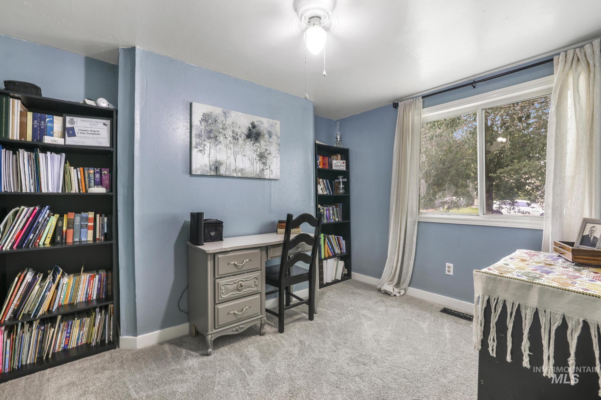 Office area featuring light carpet
