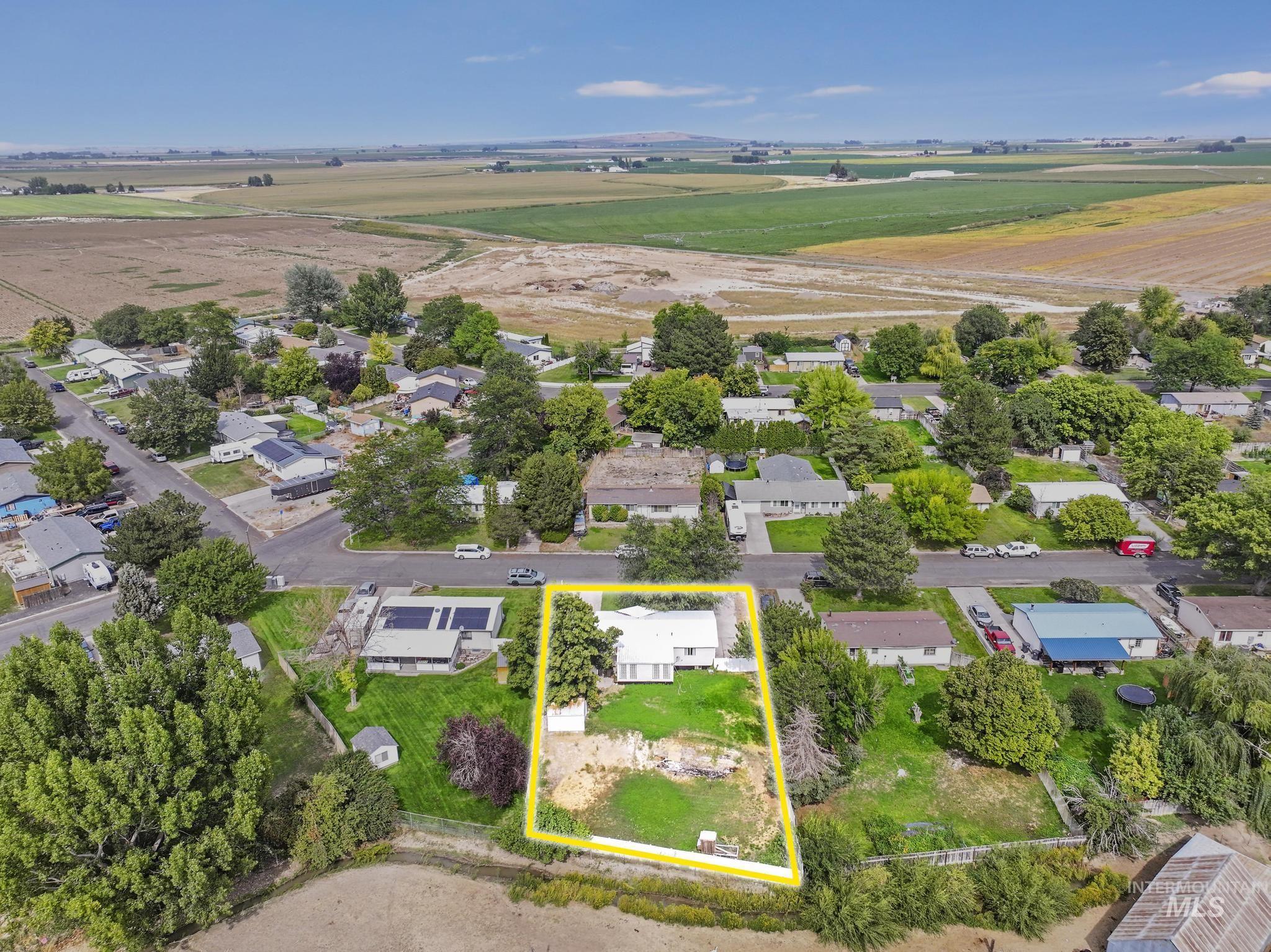 Aerial view of residential area featuring property boundaries highlighted
