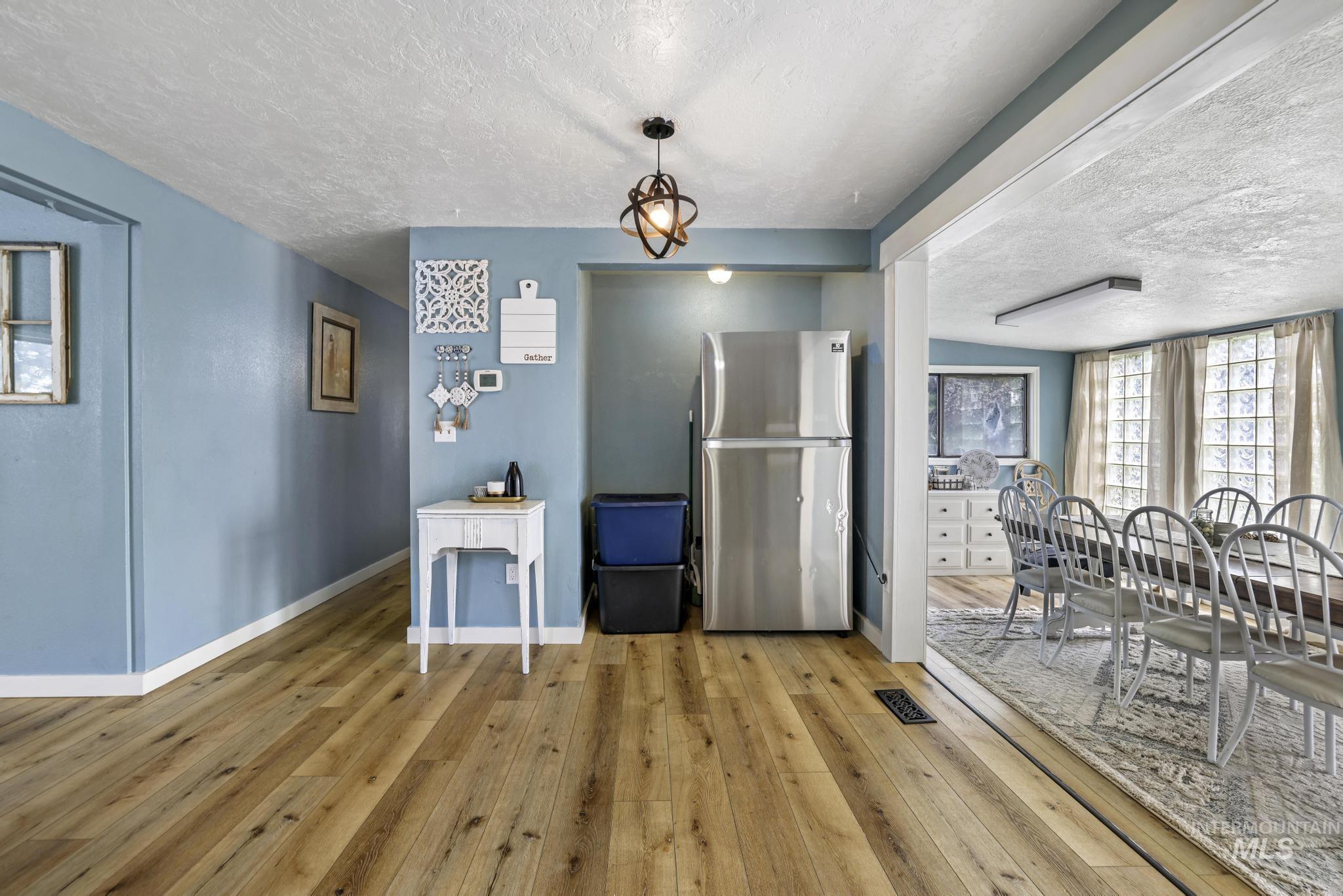 Dining space featuring a textured ceiling and wood-type flooring