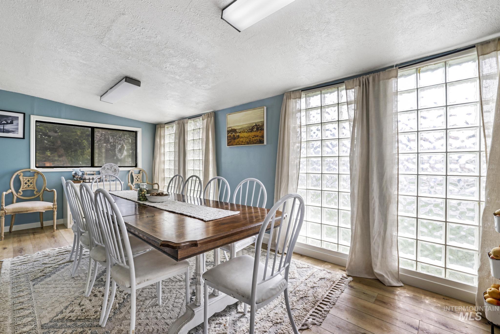 Dining room featuring hardwood / wood-style floors and a textured ceiling