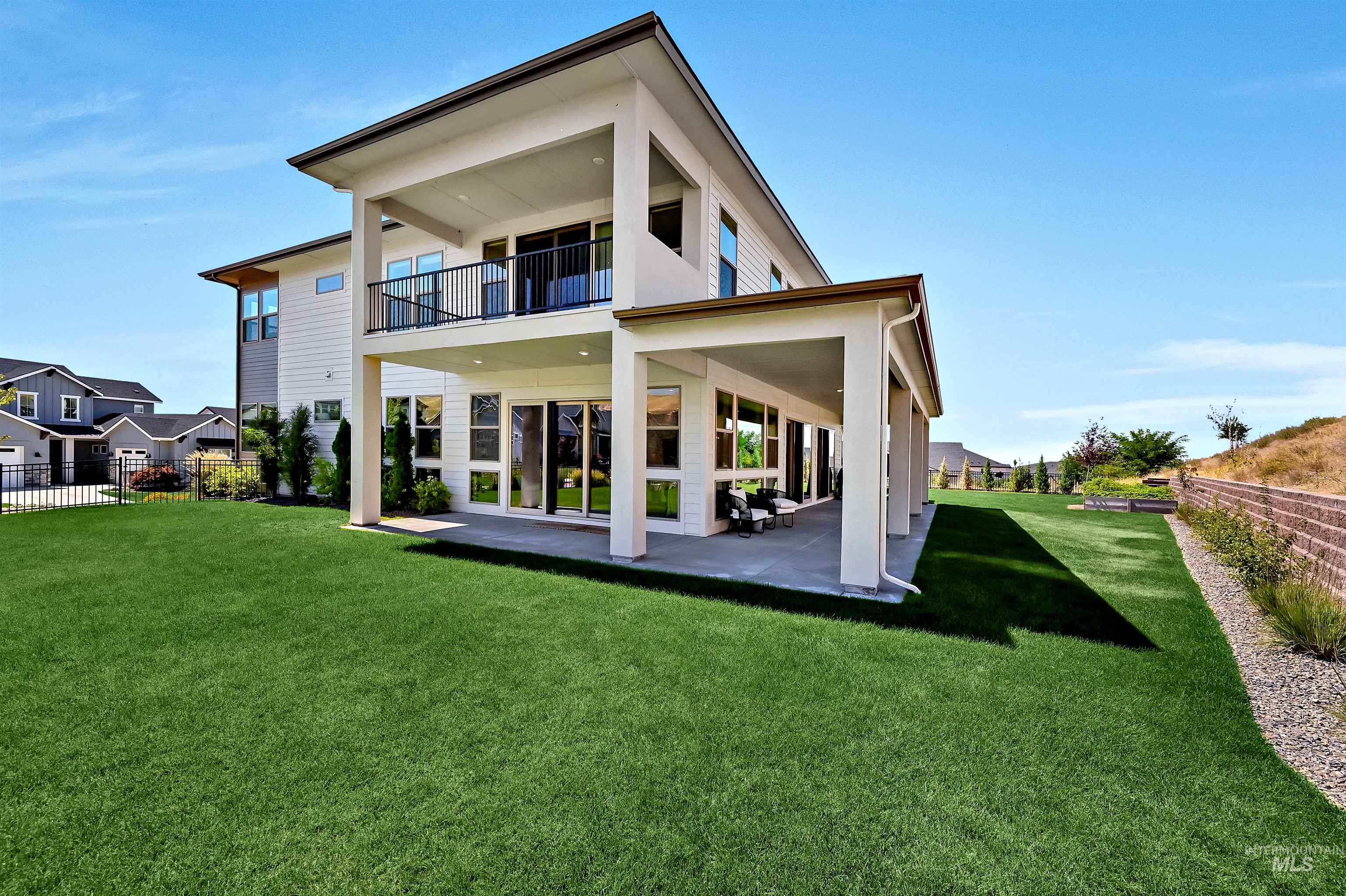 Rear view of house with a patio area and a balcony