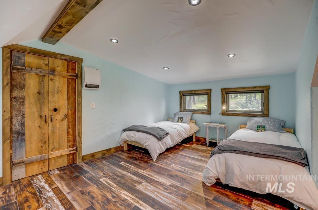Bedroom with dark wood-style flooring and recessed lighting
