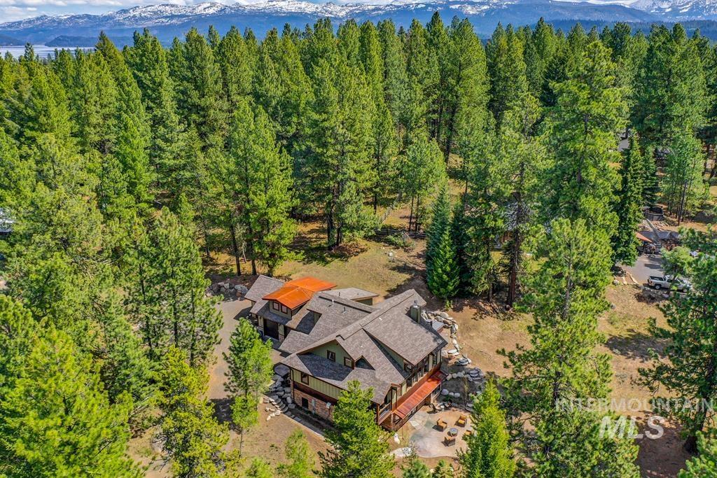 Aerial view of property and surrounding area featuring a mountain backdrop