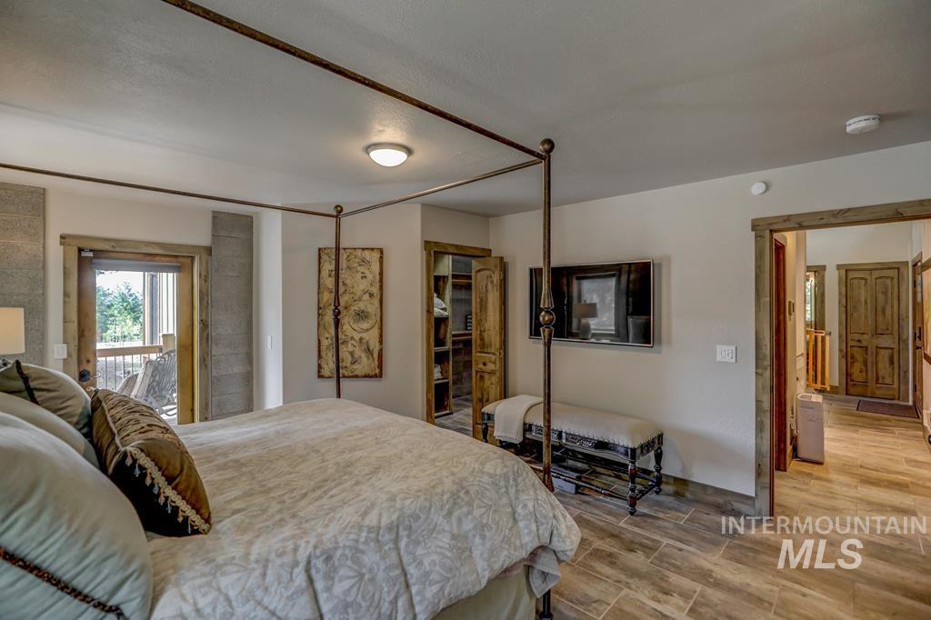 Bedroom featuring wood tiled floors and access to outside