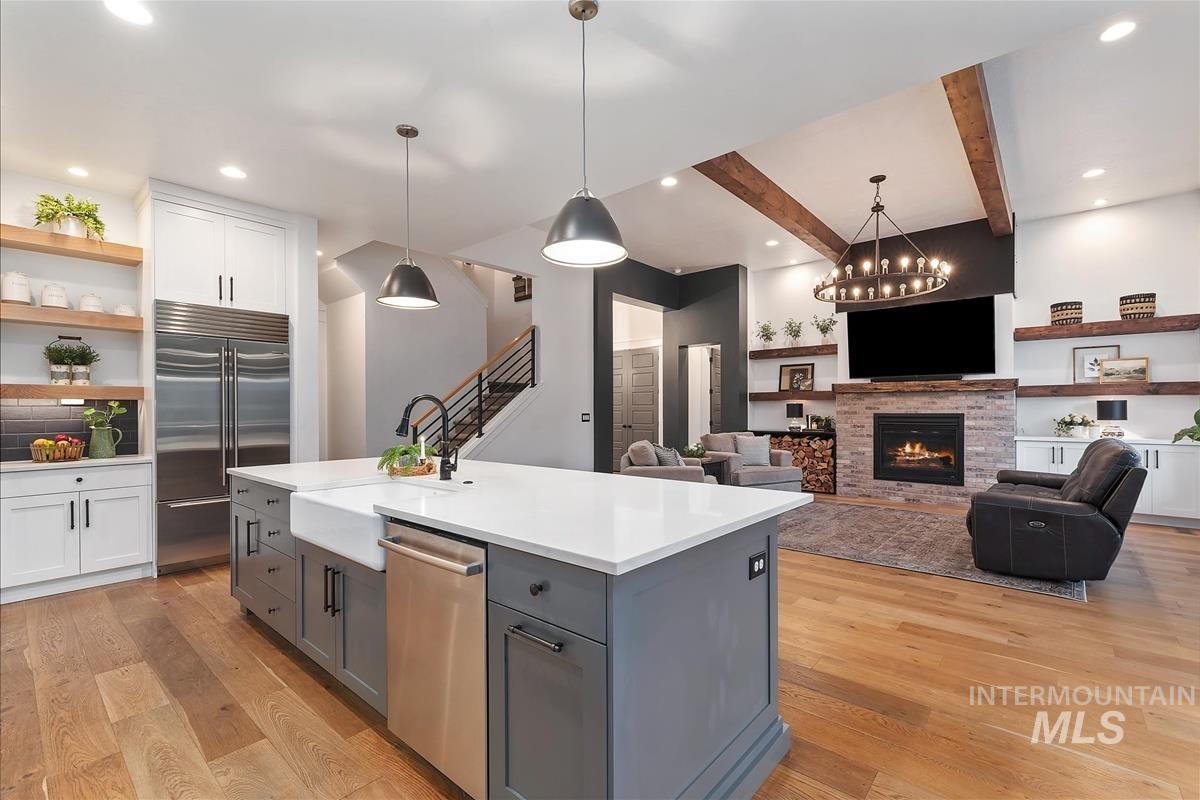 Kitchen with white cabinetry, gray cabinets, hanging light fixtures, recessed lighting, and beamed ceiling