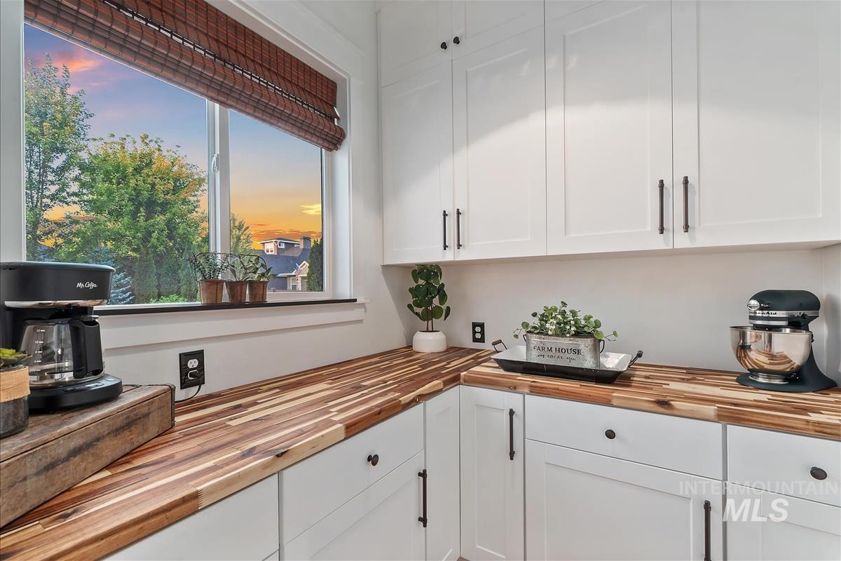 Butlers Pantry with white cabinets and butcher block counters