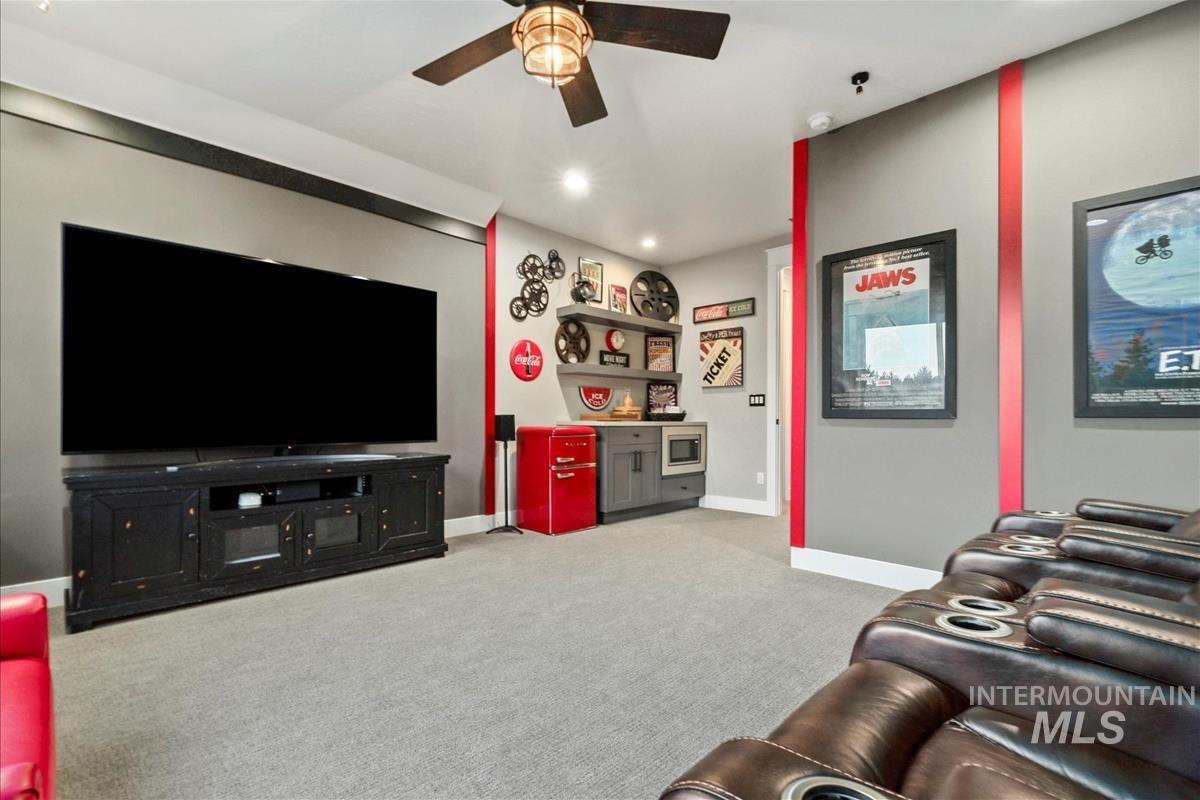 Living area featuring light carpet, recessed lighting, and ceiling fan