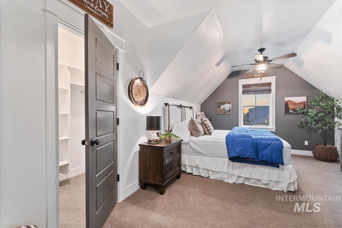 Bedroom featuring carpet, ceiling fan, and lofted ceiling