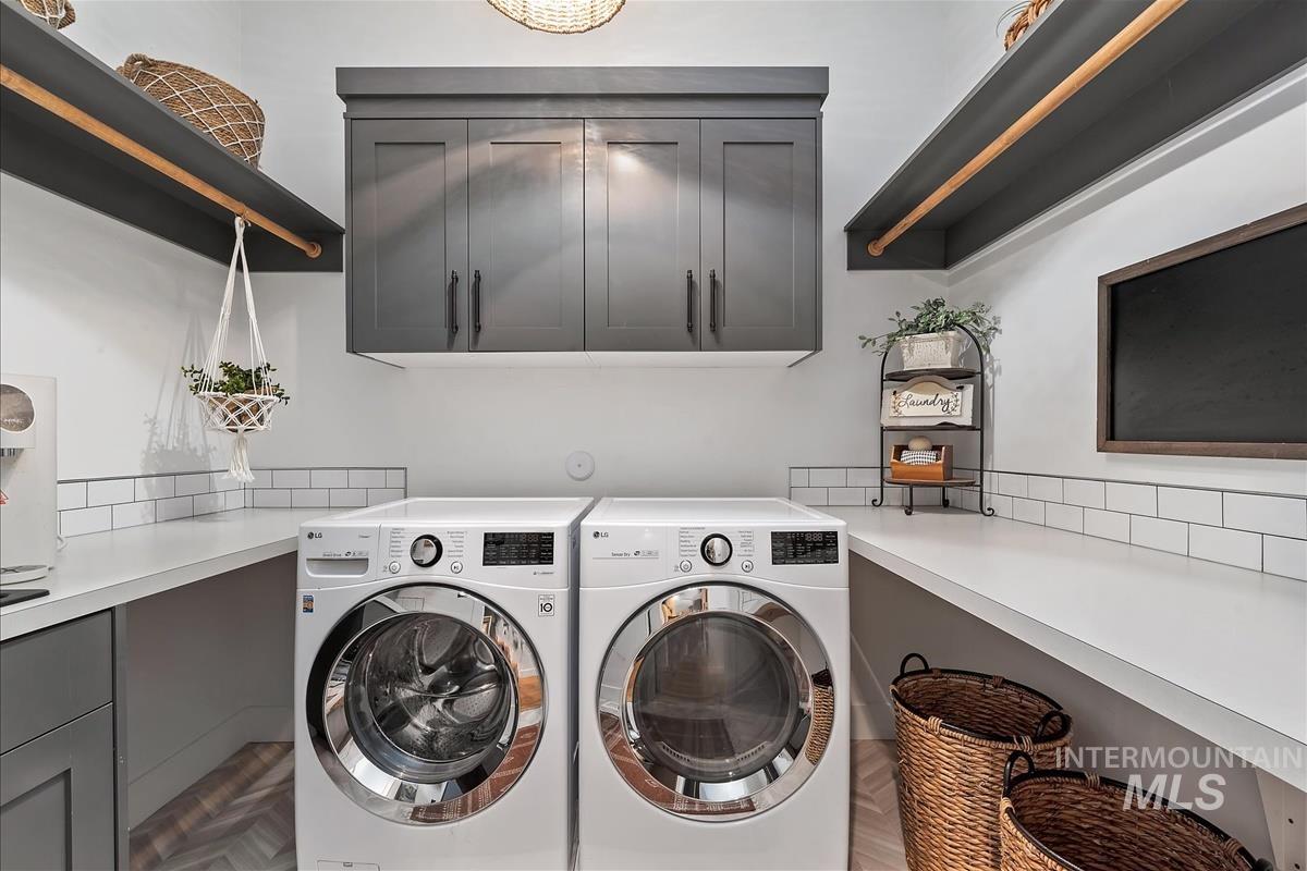 Laundry room featuring cabinet space and washer and clothes dryer