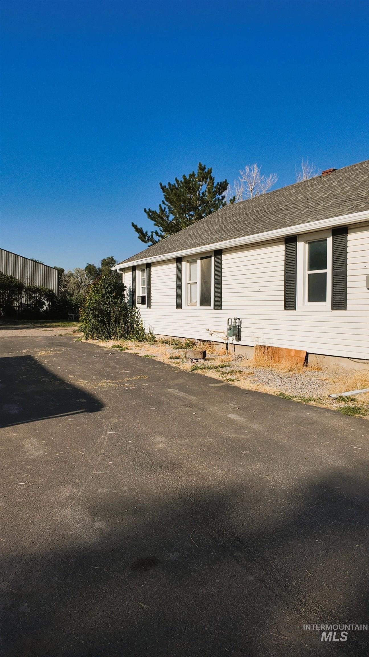View of front of property with roof with shingles