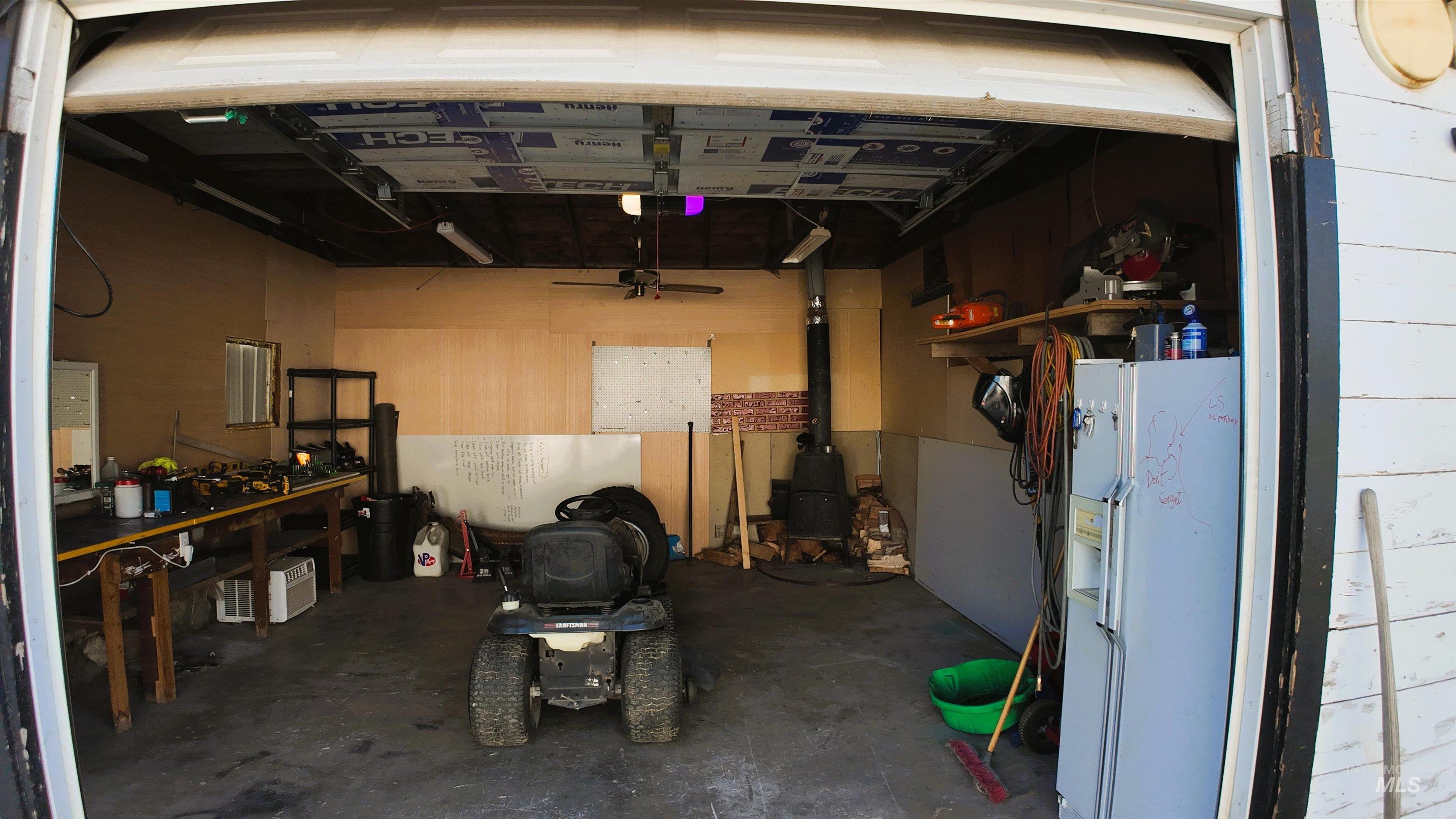 Garage with white refrigerator with ice dispenser