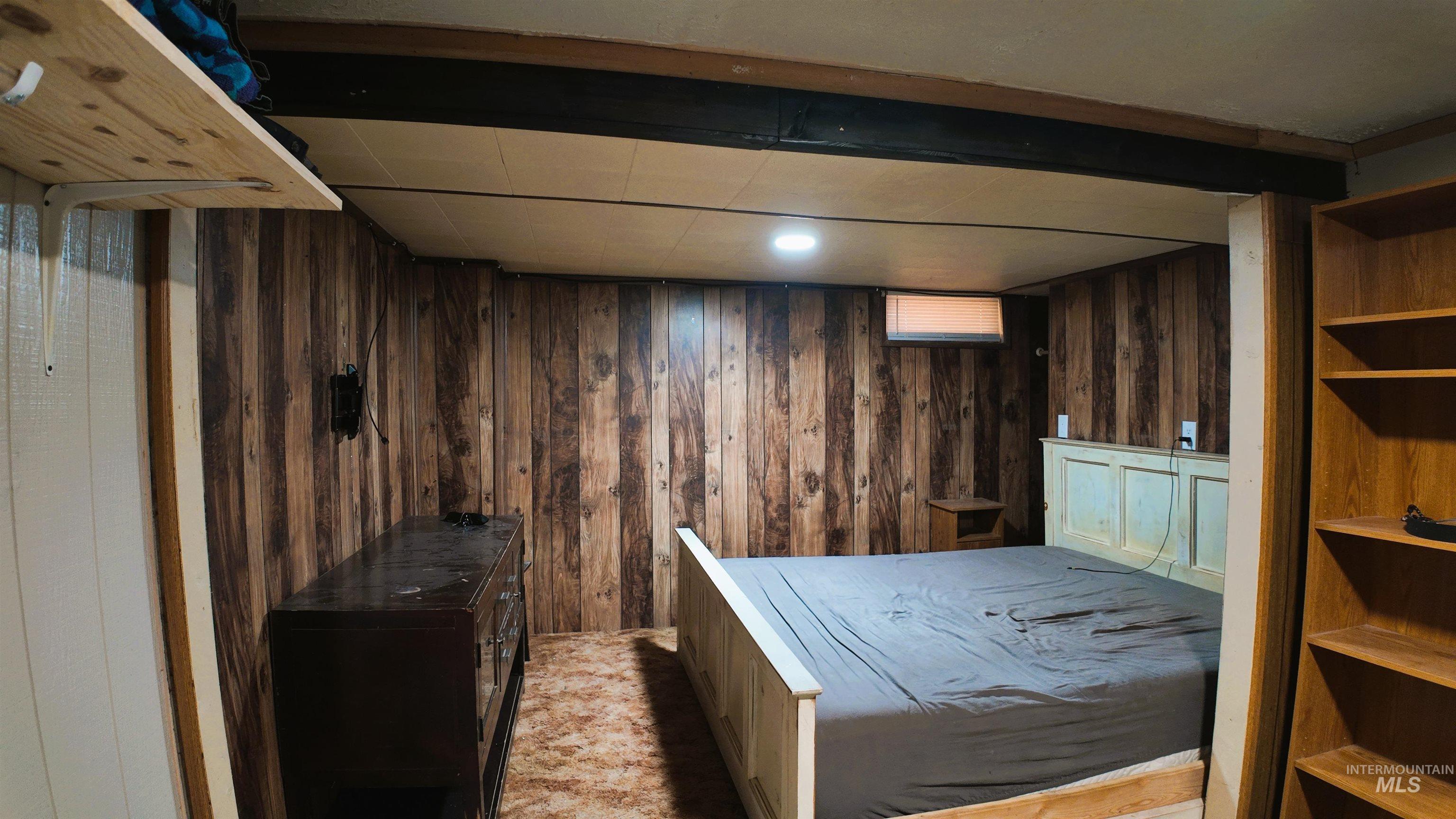Bedroom with wooden walls