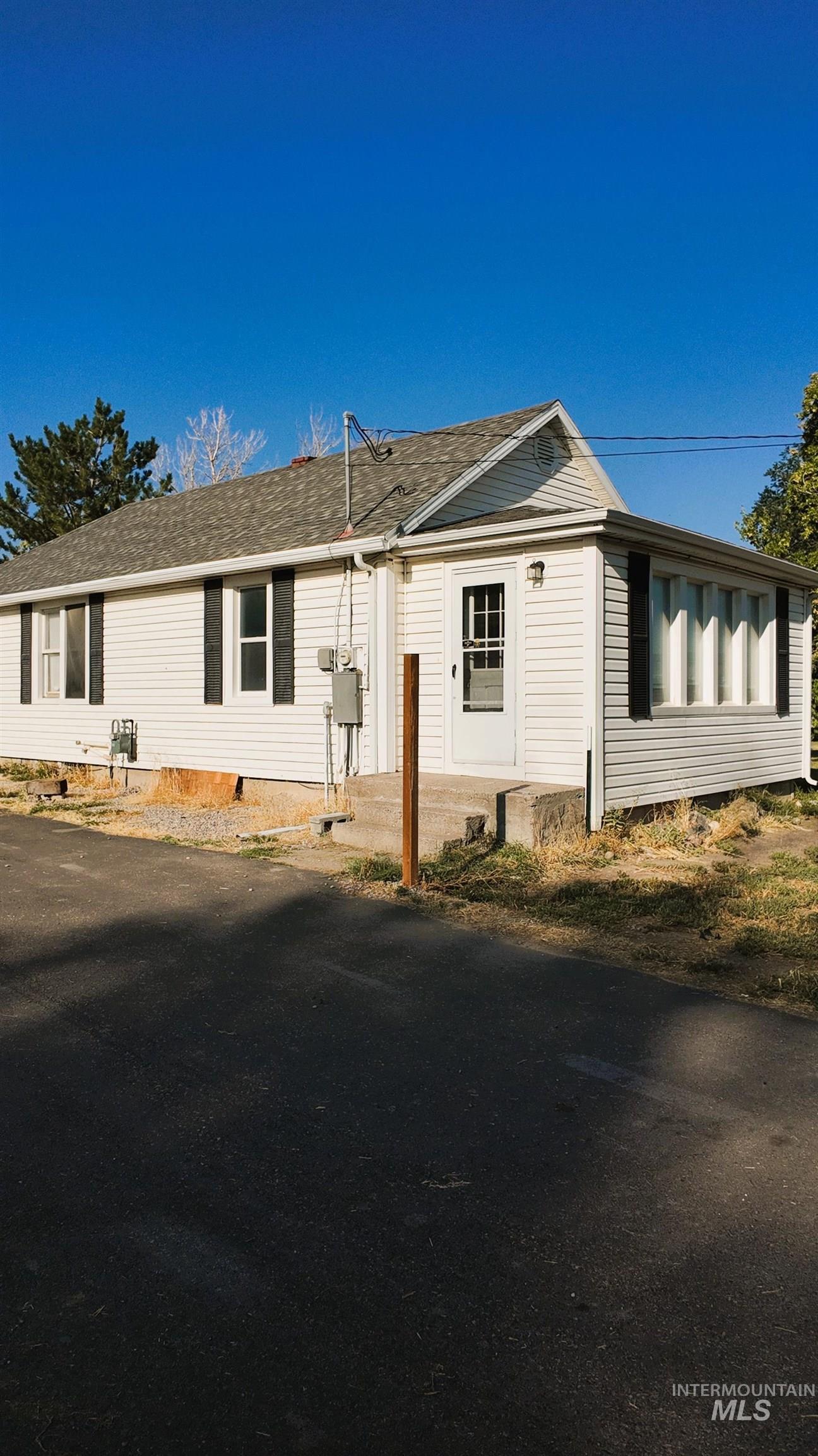 View of property exterior with a shingled roof