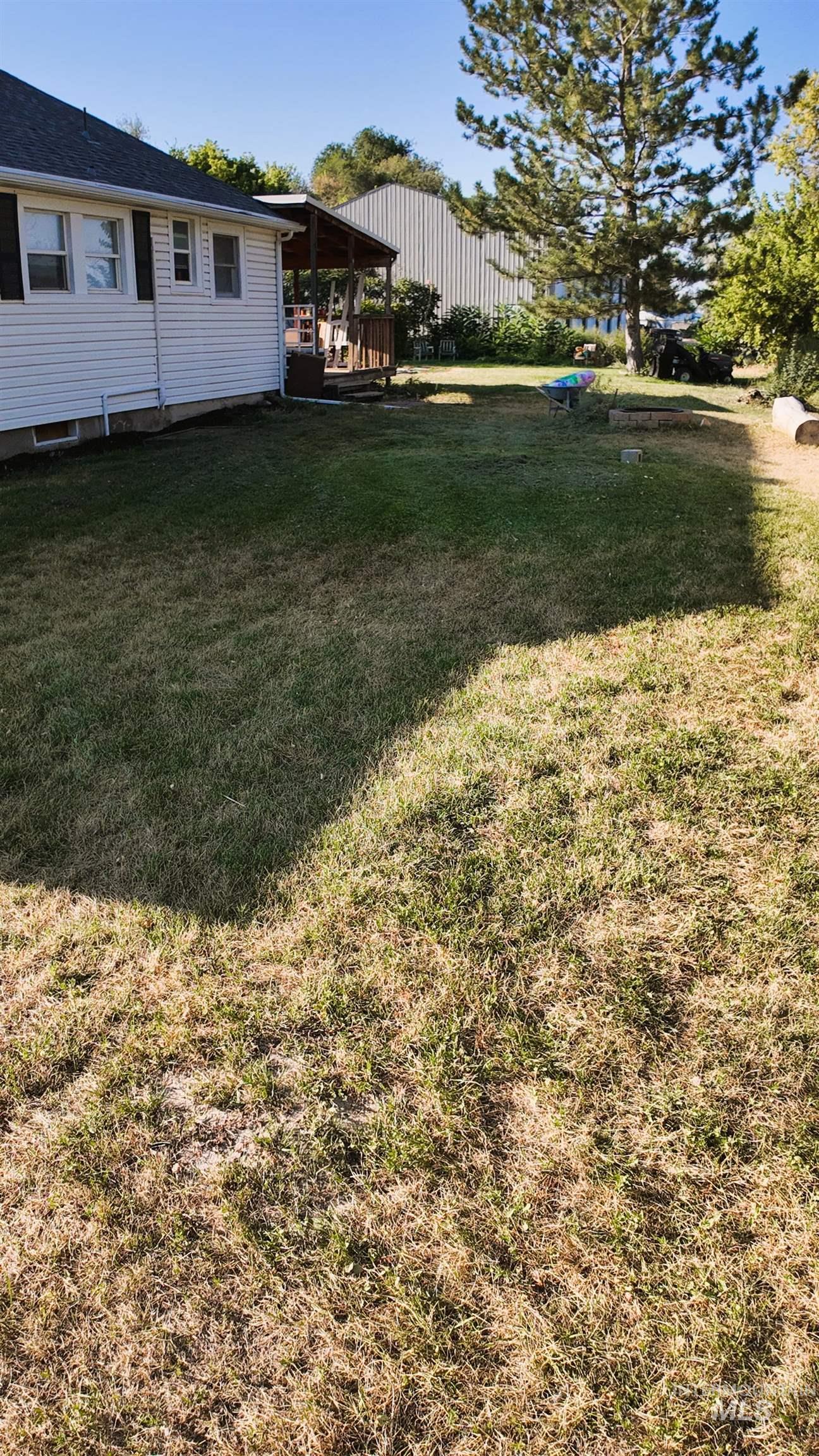 View of green lawn featuring a gazebo and a deck