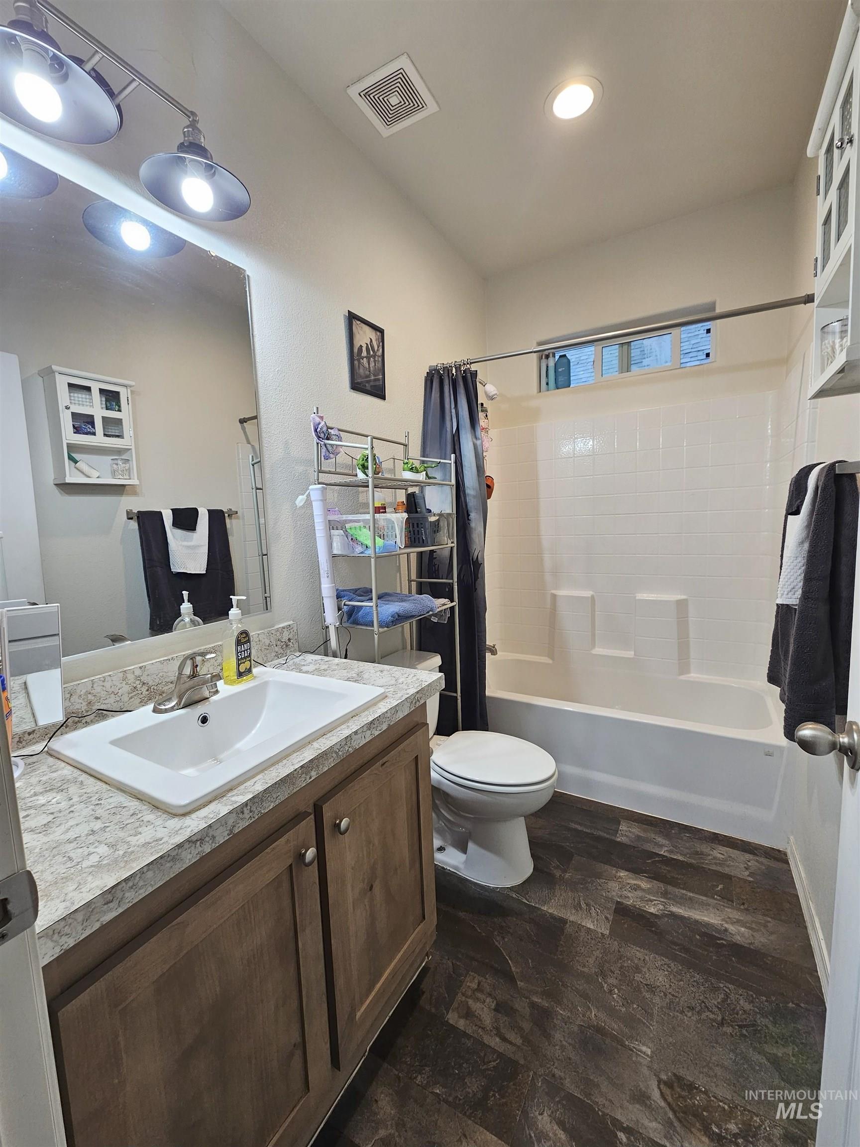 Full bathroom featuring shower / tub combo and vanity