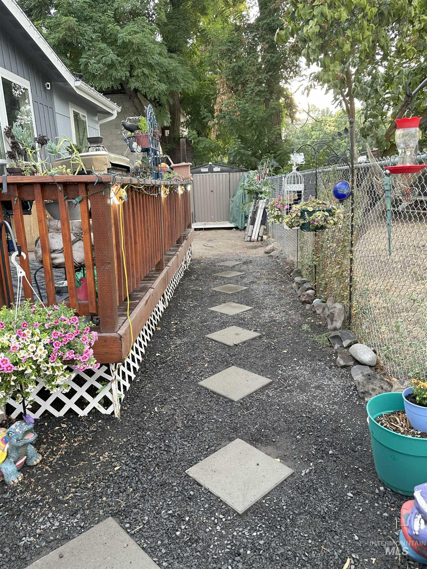 View of yard featuring a wooden deck and an outdoor structure