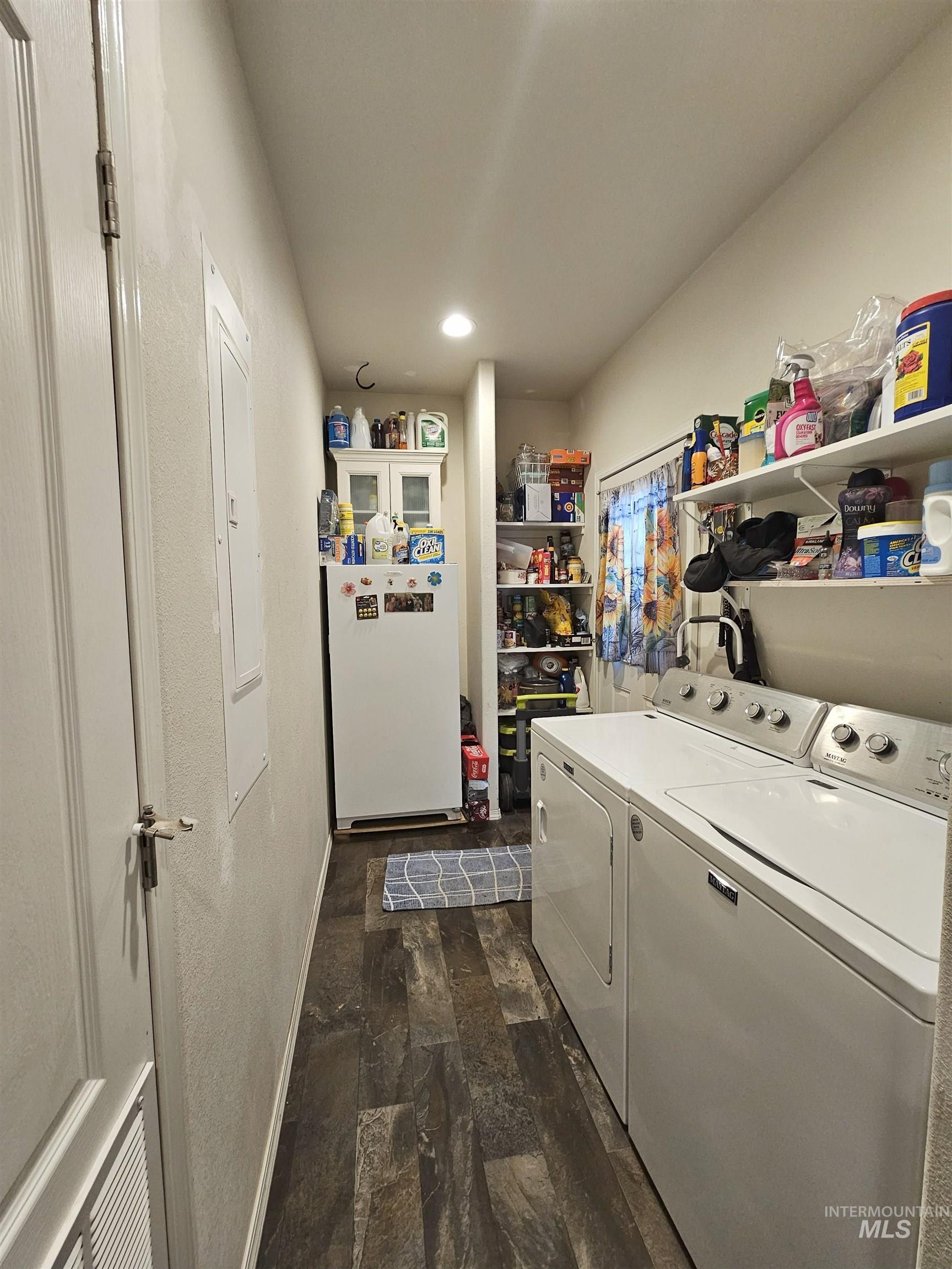 Laundry room with washing machine and clothes dryer, recessed lighting, and dark wood-style flooring