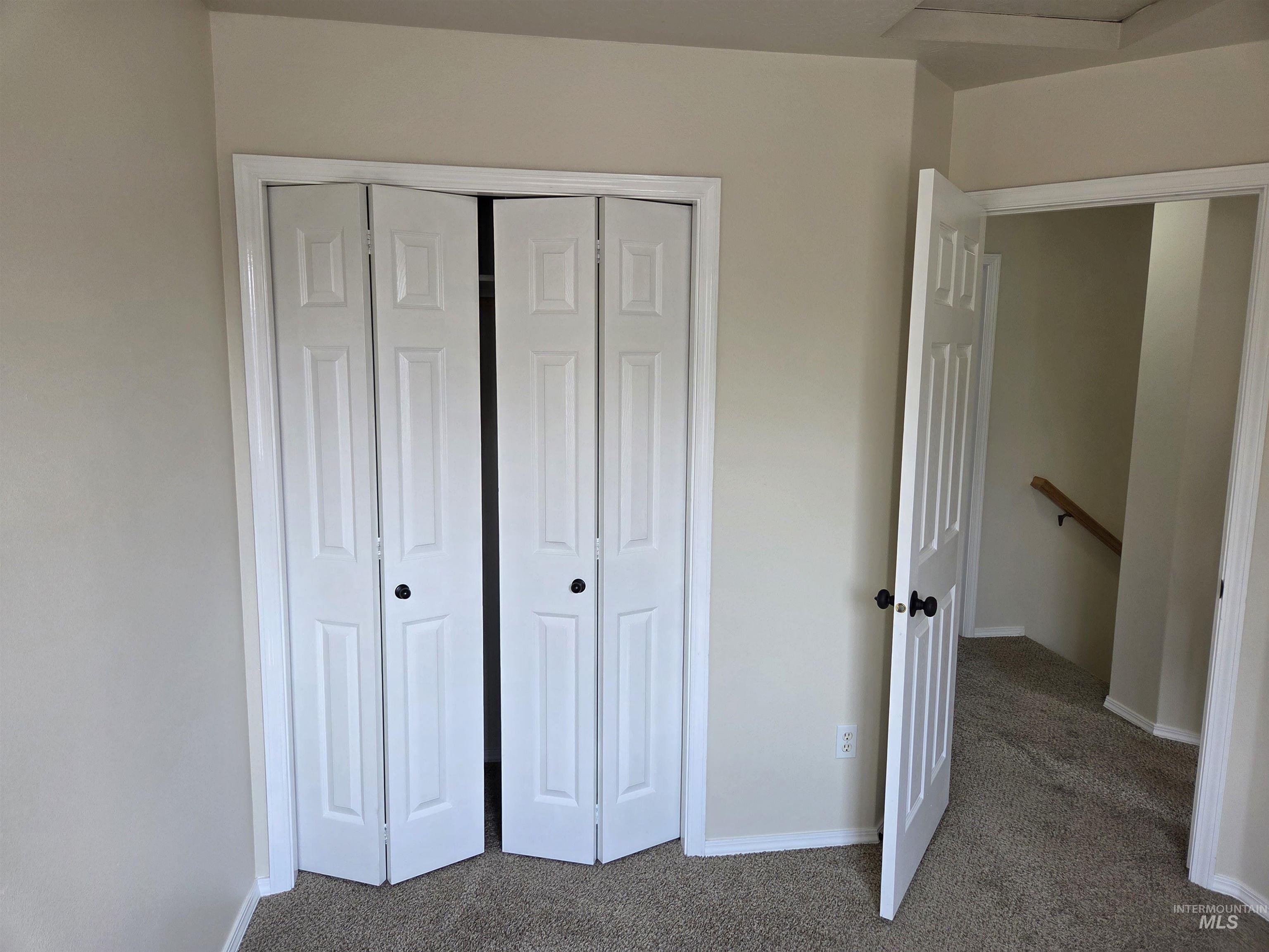 Unfurnished bedroom featuring carpet flooring and a closet