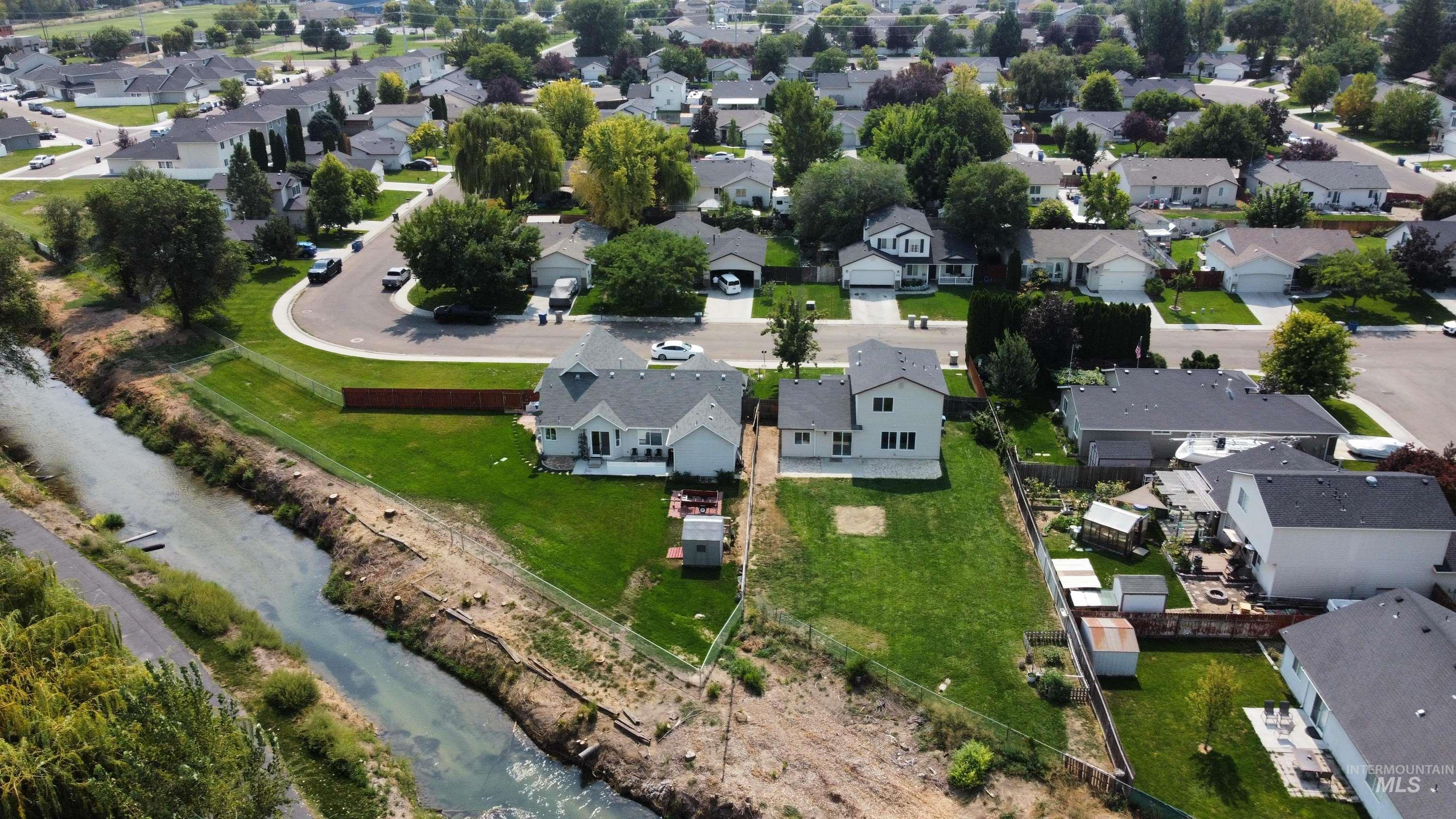 Aerial view of property's location with nearby suburban area and a large body of water