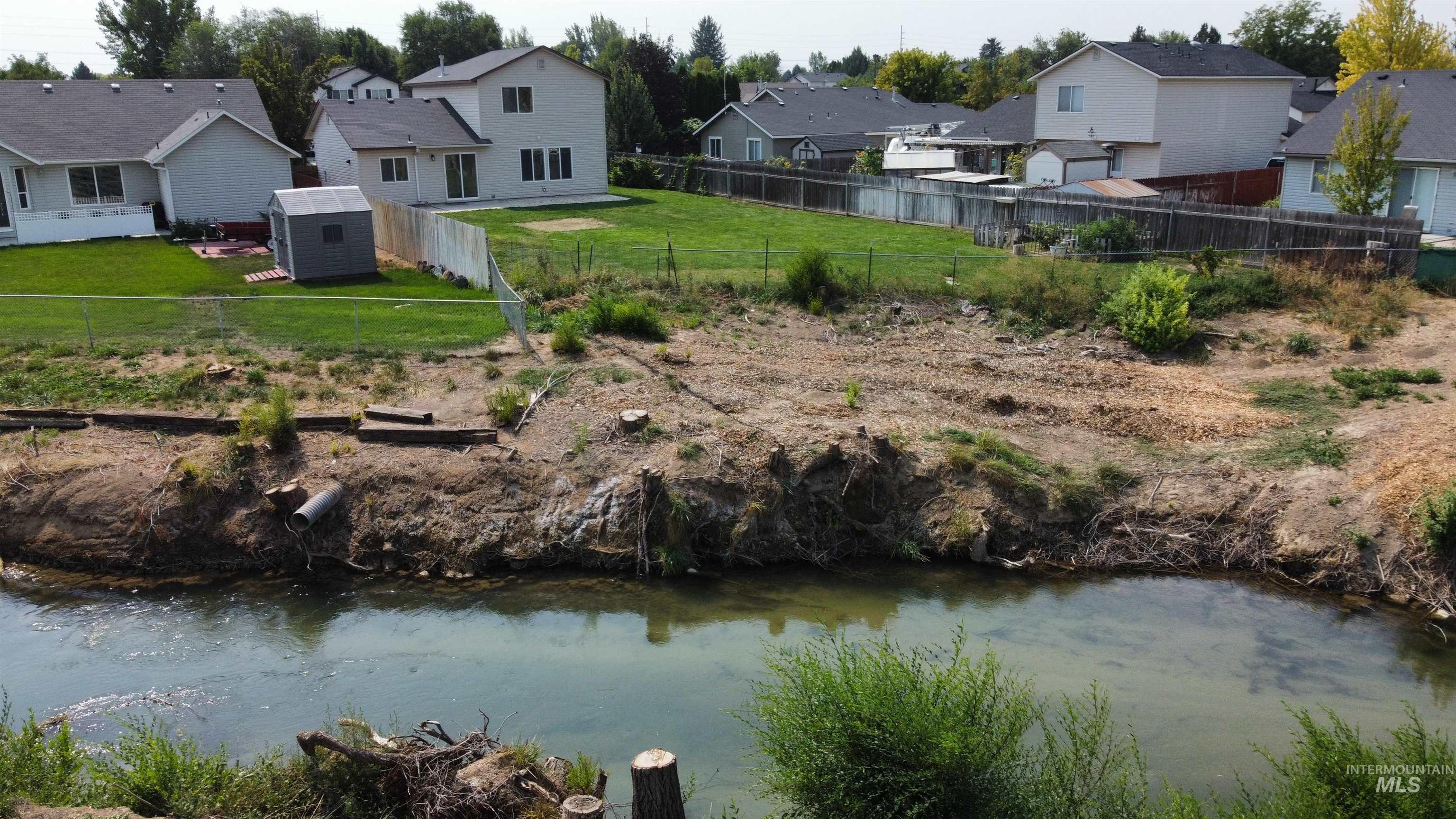 Water view featuring nearby suburban area and a fenced backyard