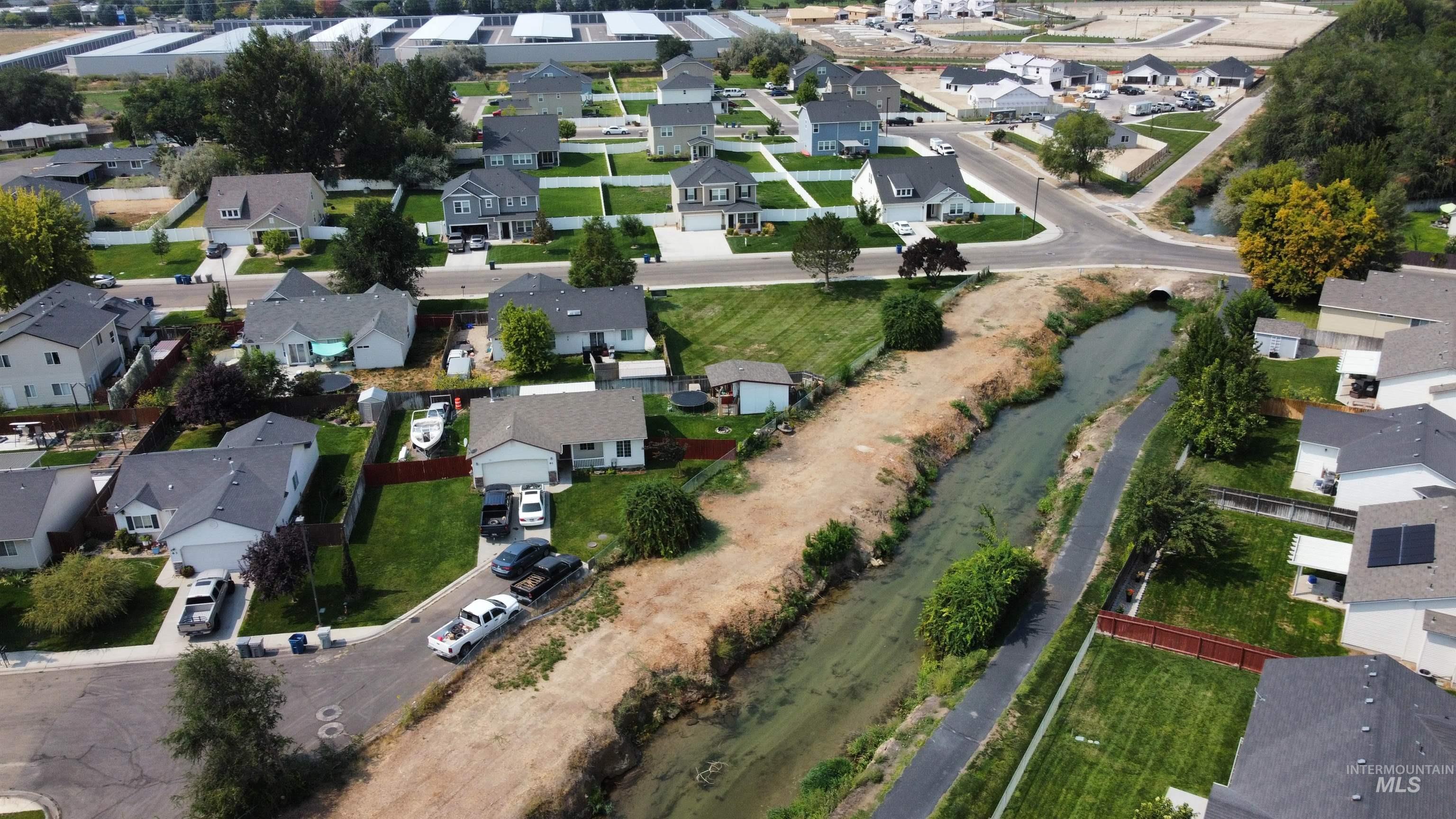 Aerial view of property's location featuring nearby suburban area