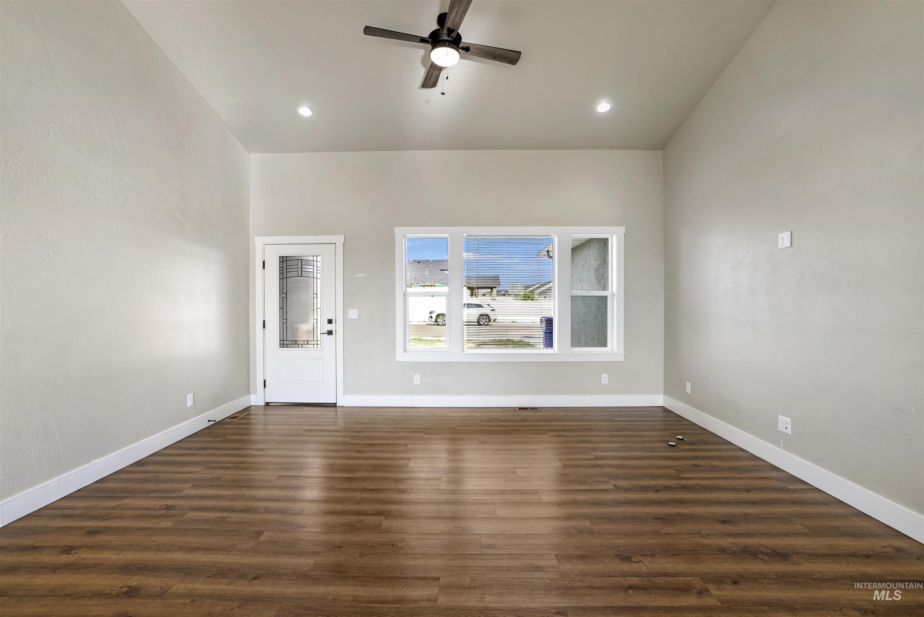 Foyer entrance with dark wood-style flooring, a ceiling fan, high vaulted ceiling, and recessed lighting