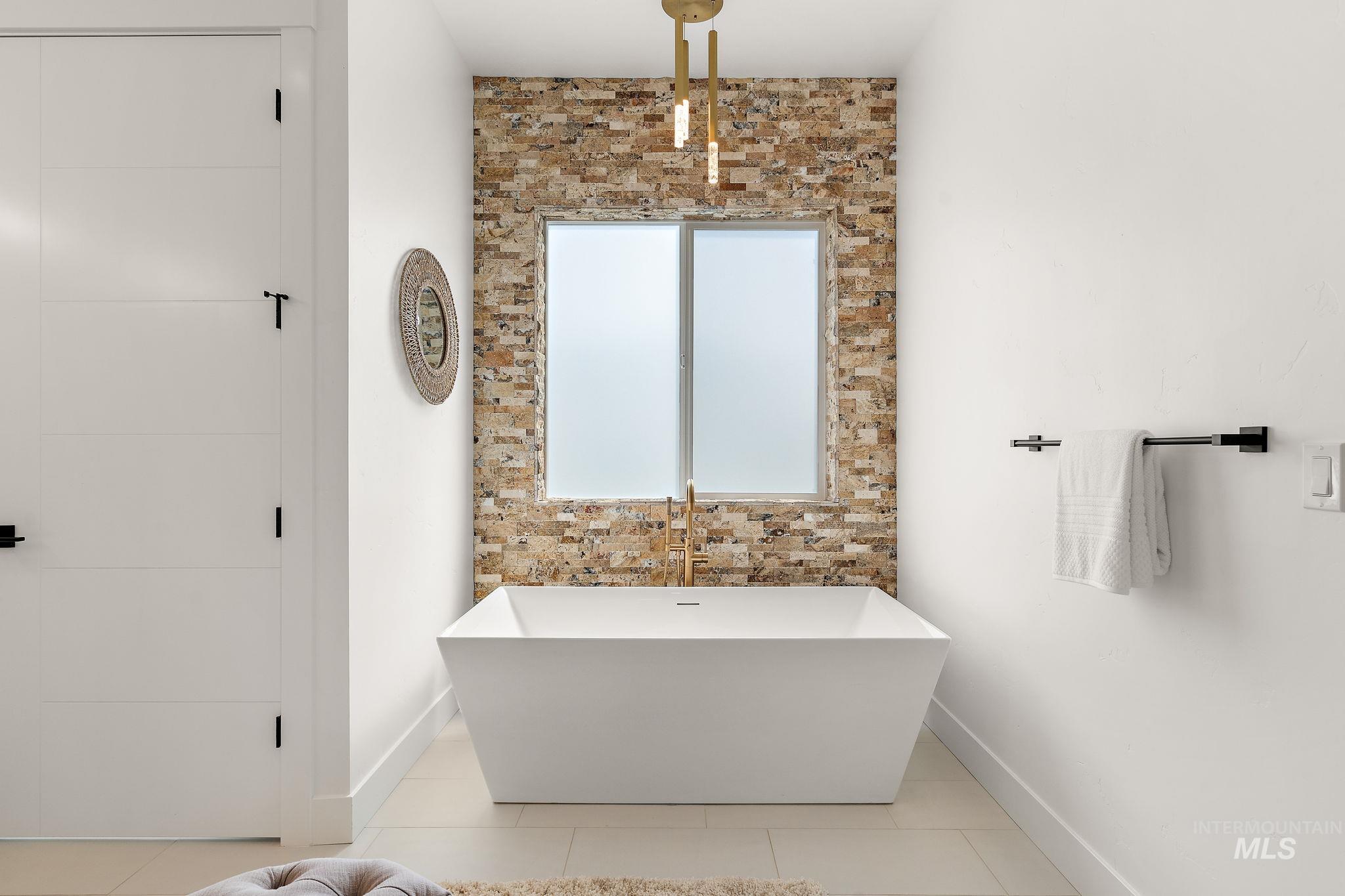 Bathroom featuring a soaking tub and tile patterned floors