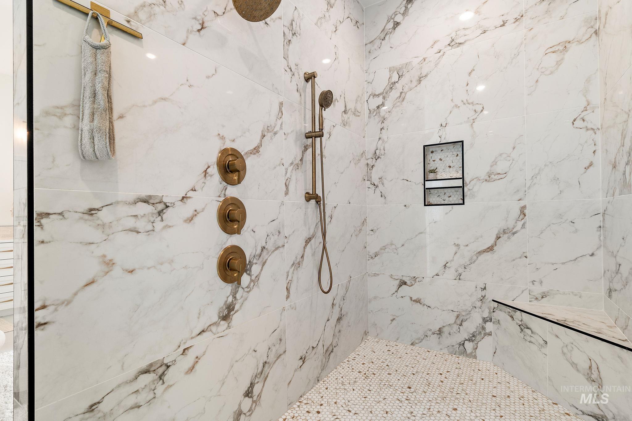 Full bathroom featuring a marble finish shower