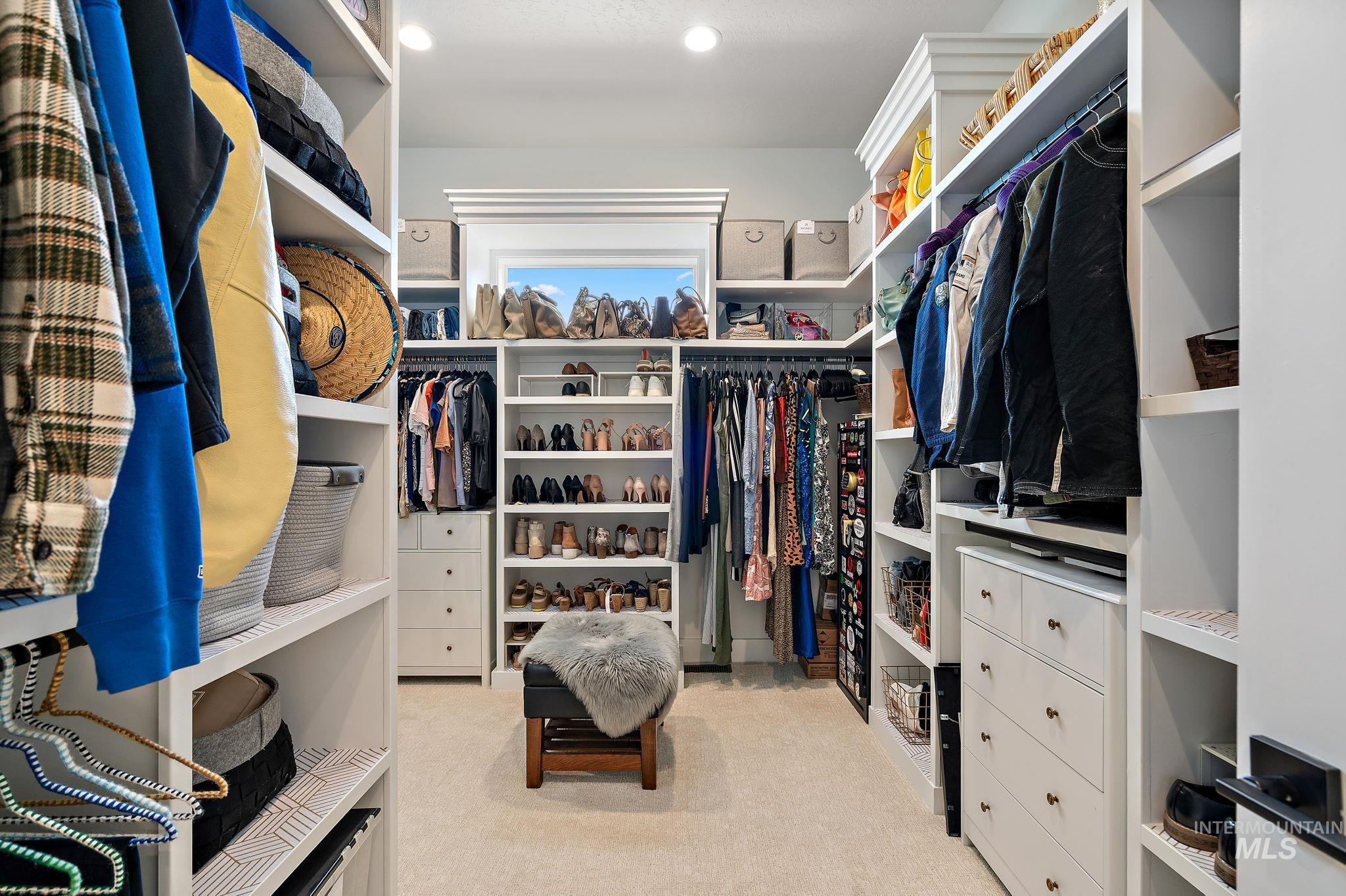 Spacious closet with light carpet