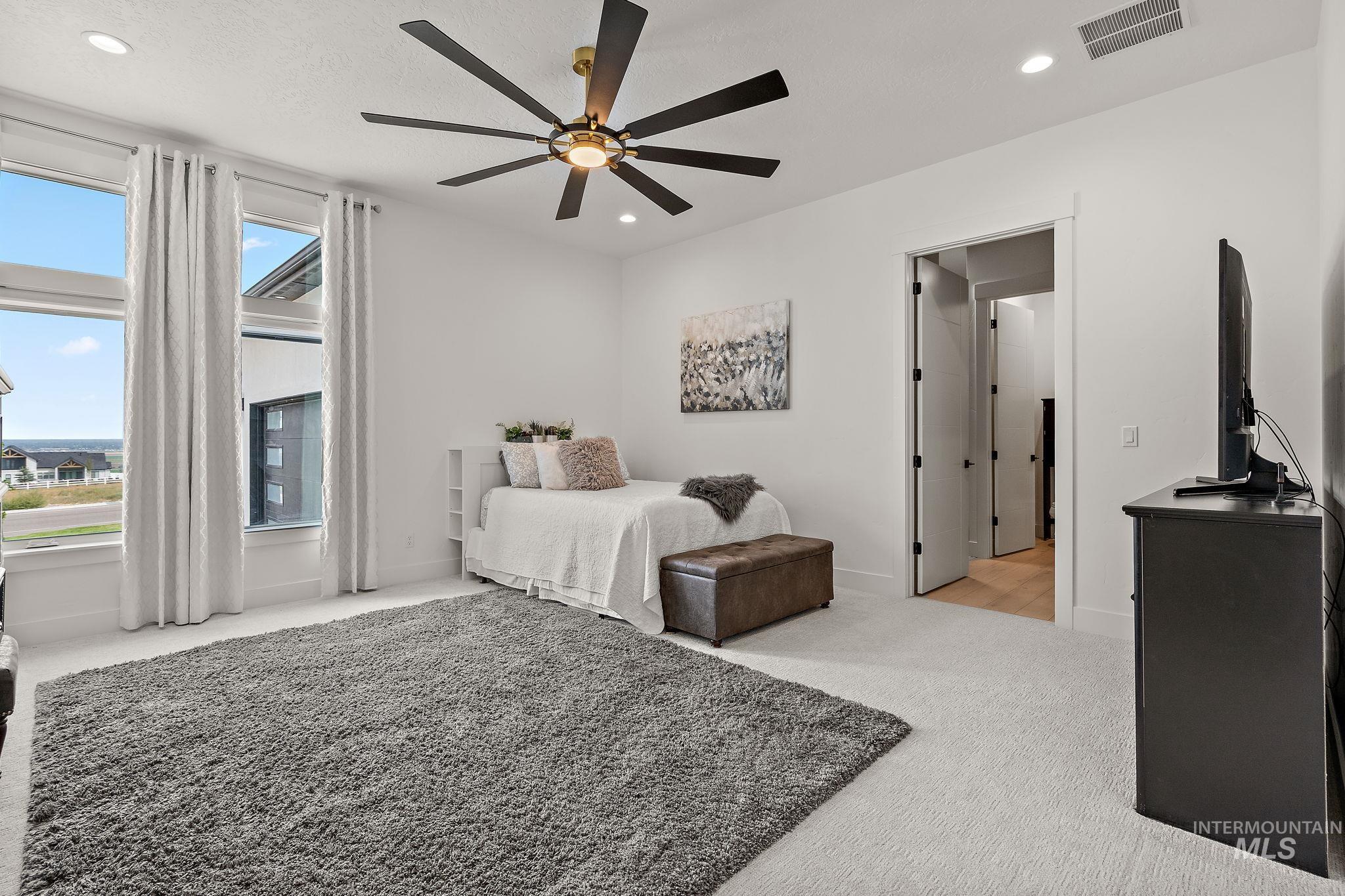 Bedroom featuring light colored carpet, recessed lighting, and a ceiling fan