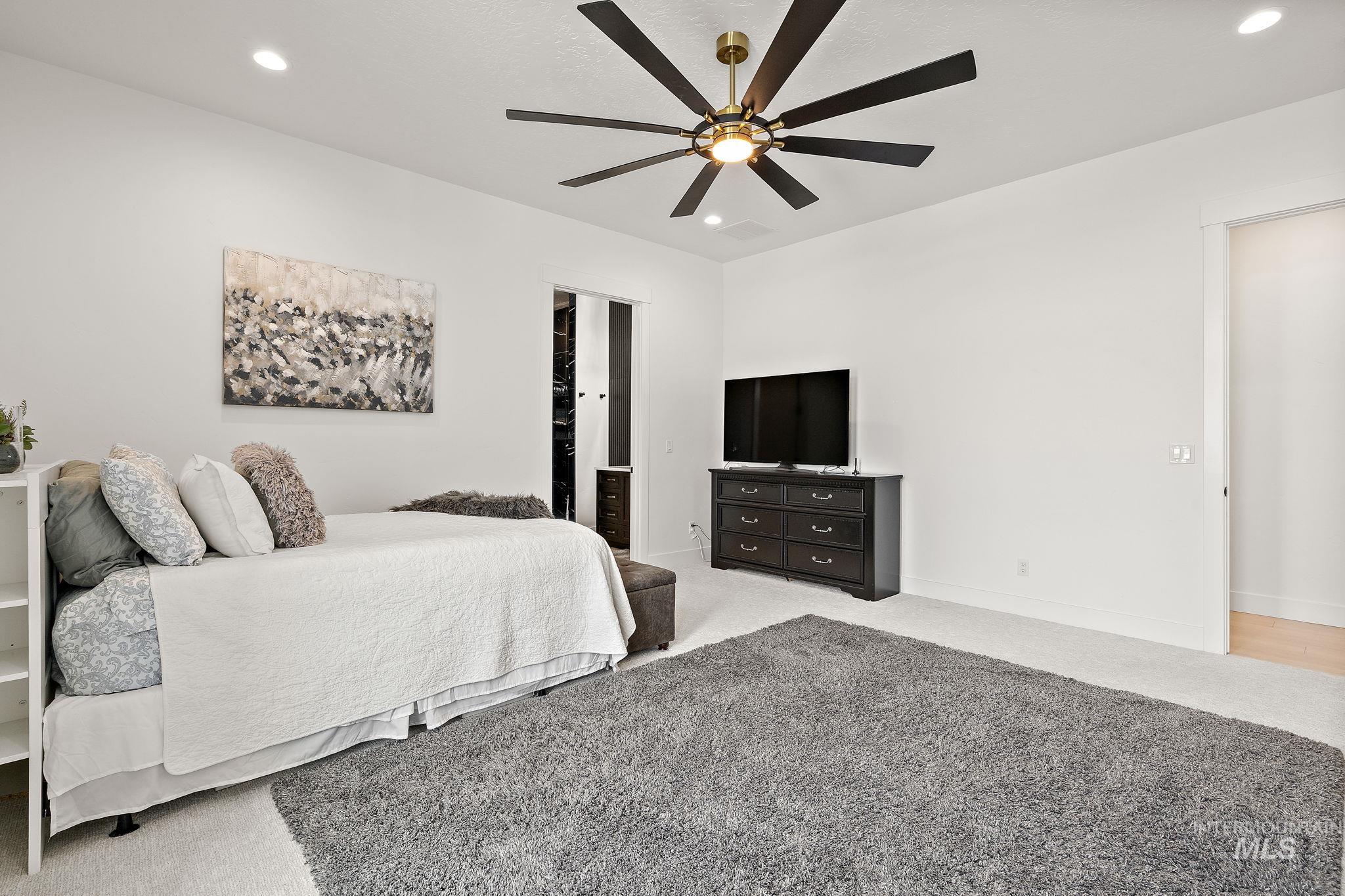 Carpeted bedroom with recessed lighting and a ceiling fan