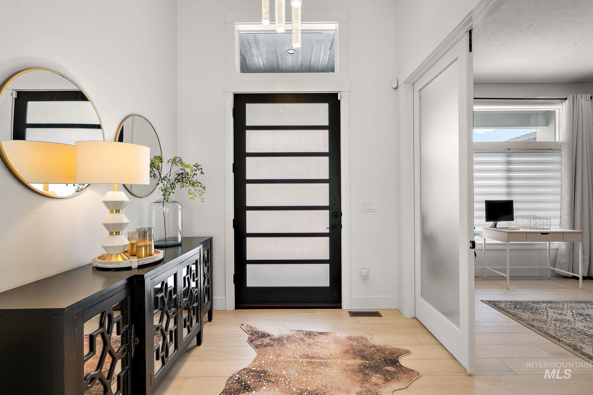 Entryway with baseboards and light wood finished floors
